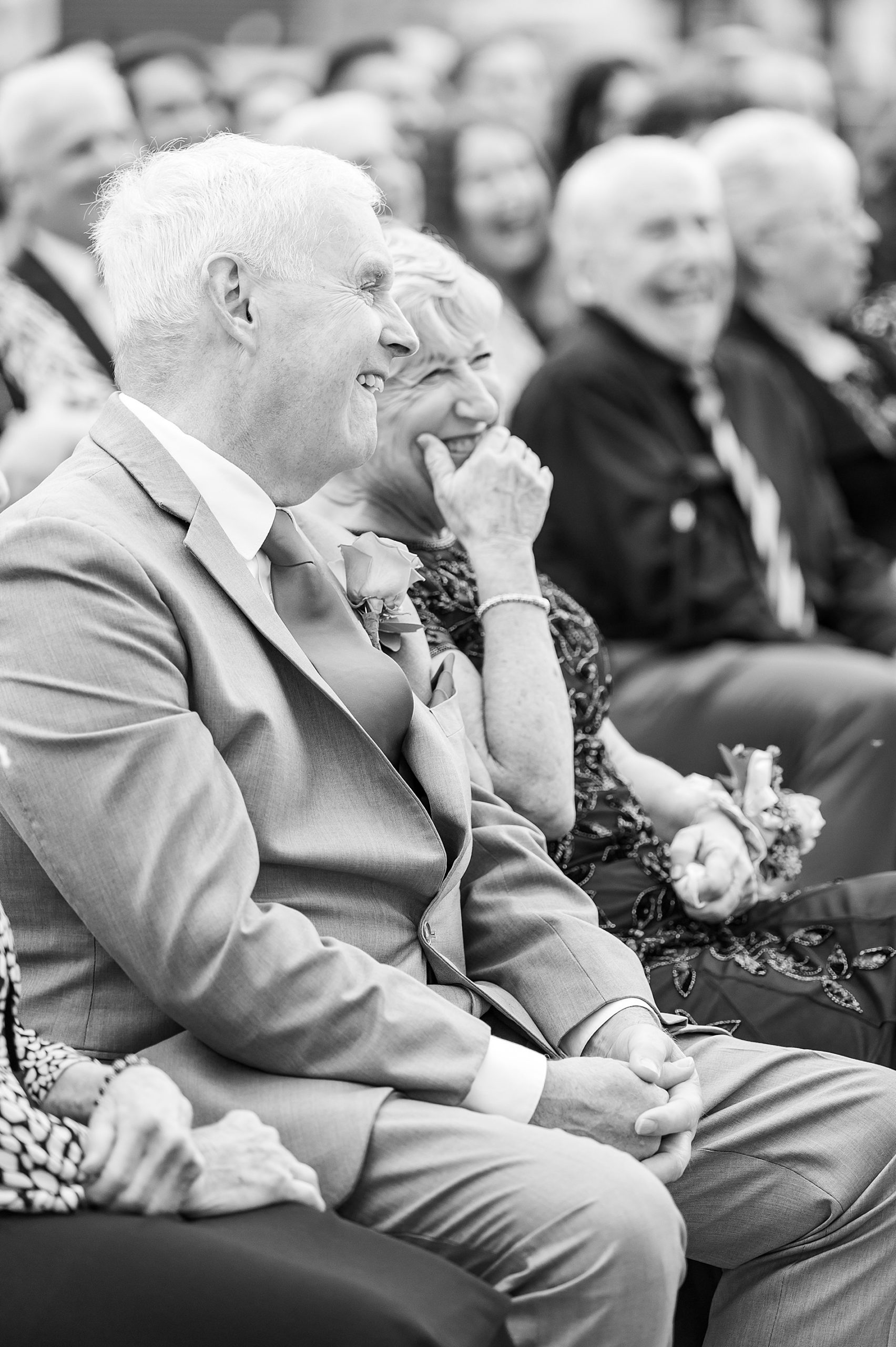 wedding guests laugh during ceremony
