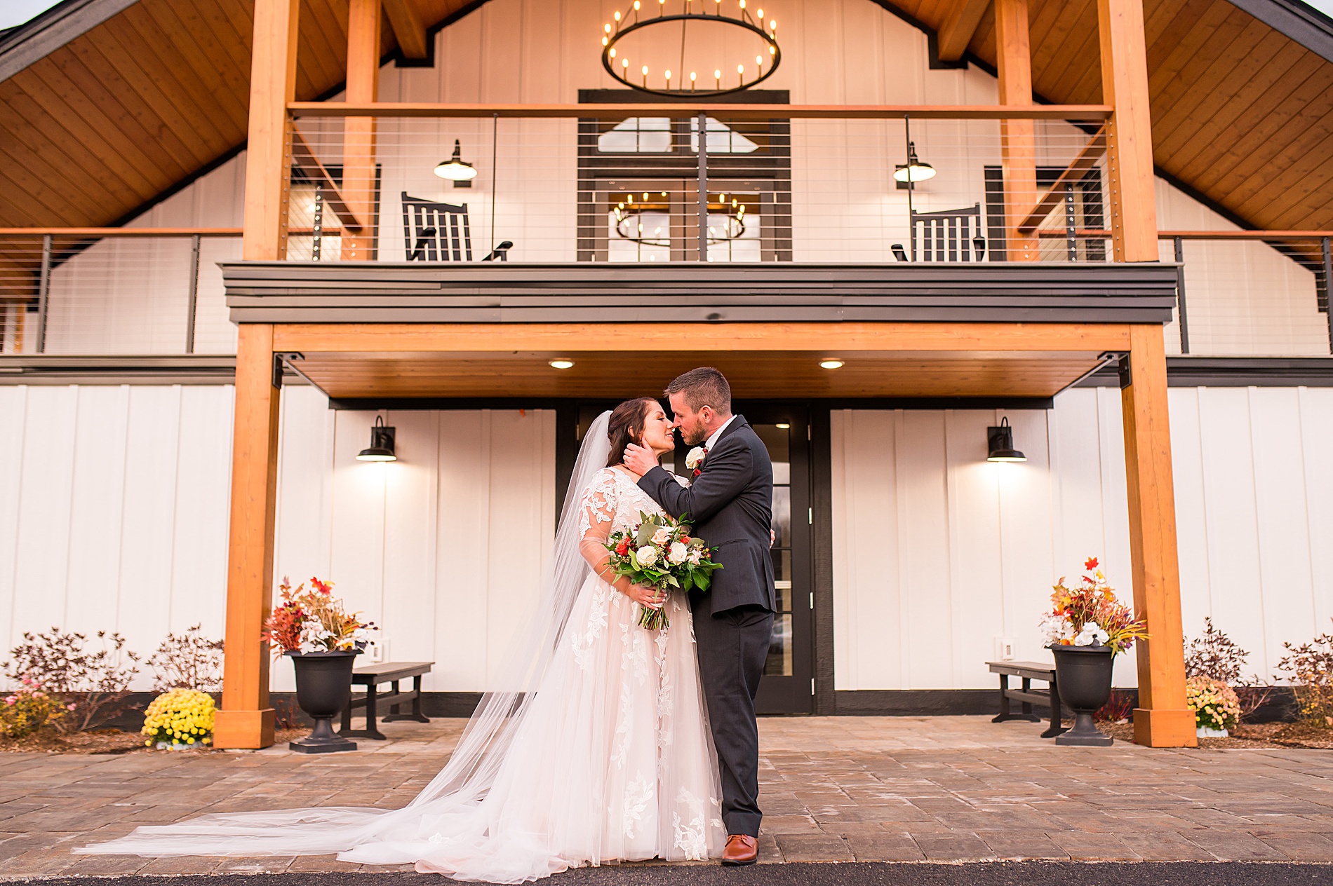 newlyweds in front of The LakeHouse at Owl's Nest Resort