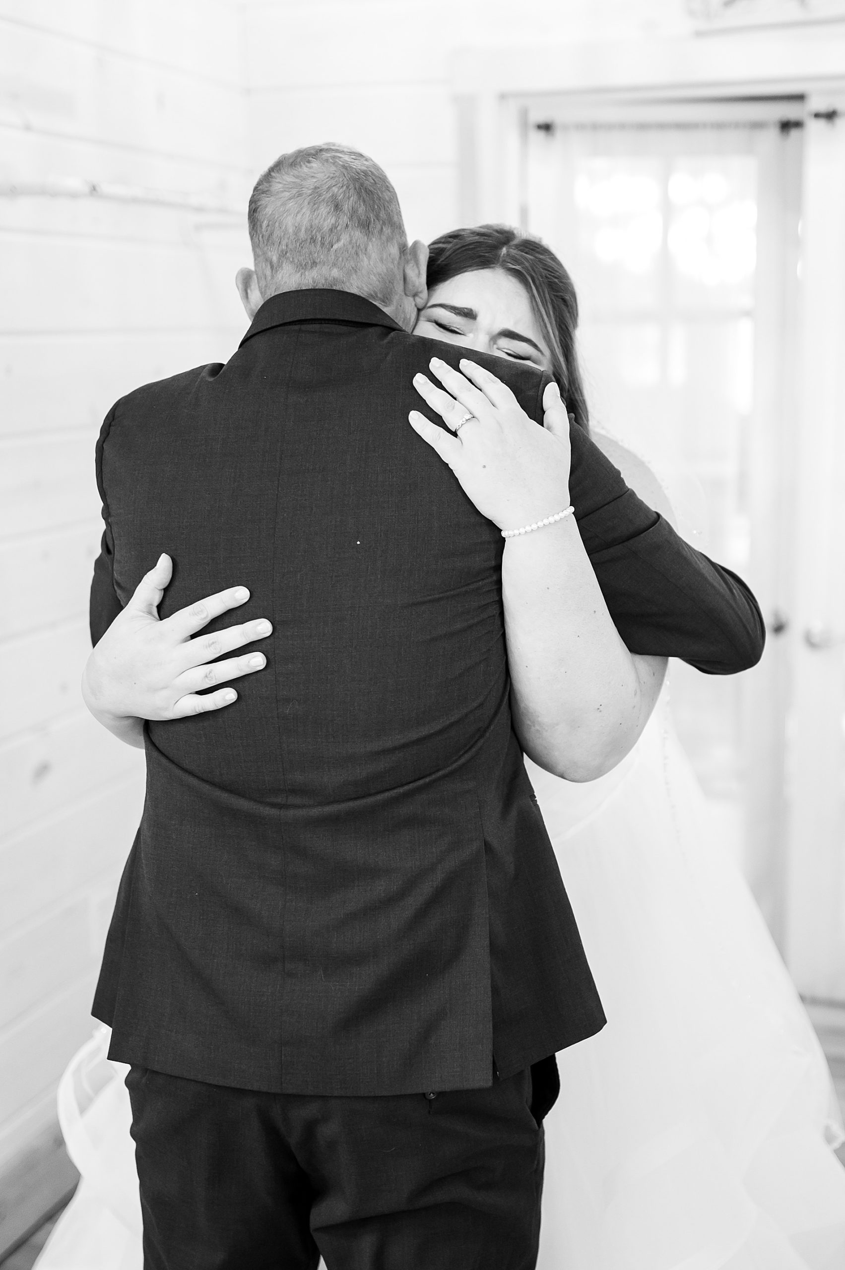 bride and father hug