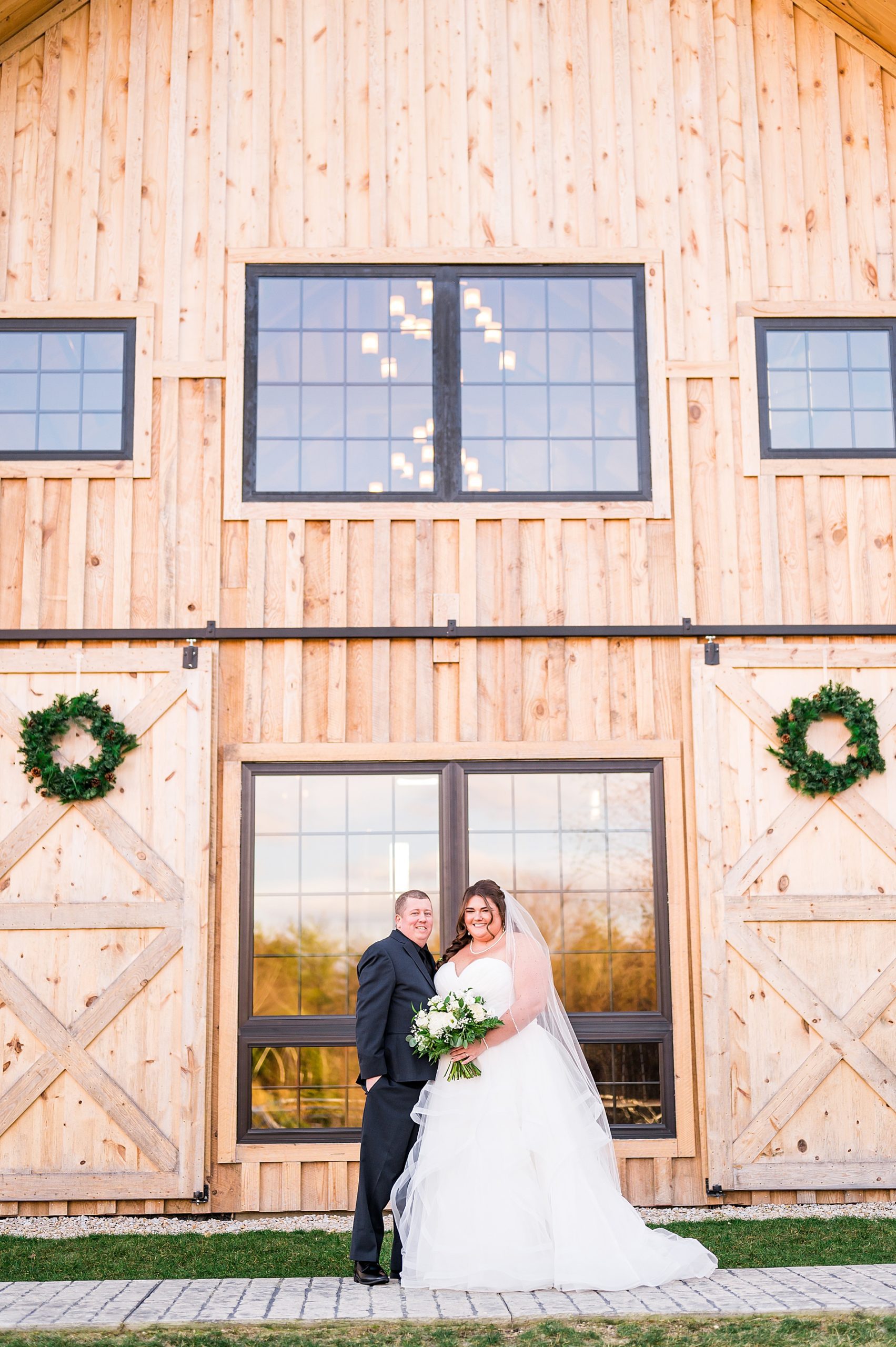 wedding portraits in front of rustic barn at The Barn on Bull Meadow in Concord NH