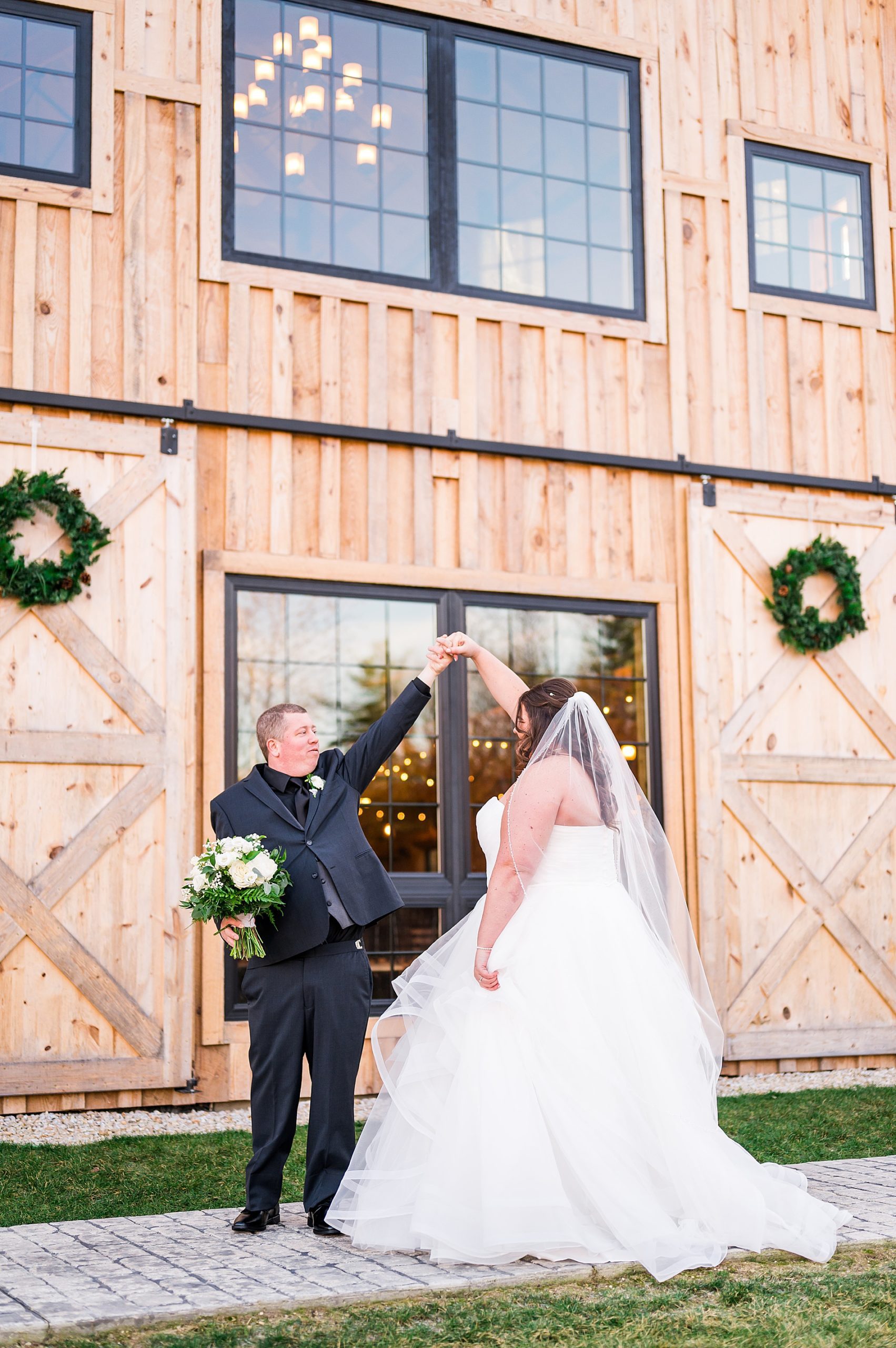 groom dances with his bride during wedding portraits 