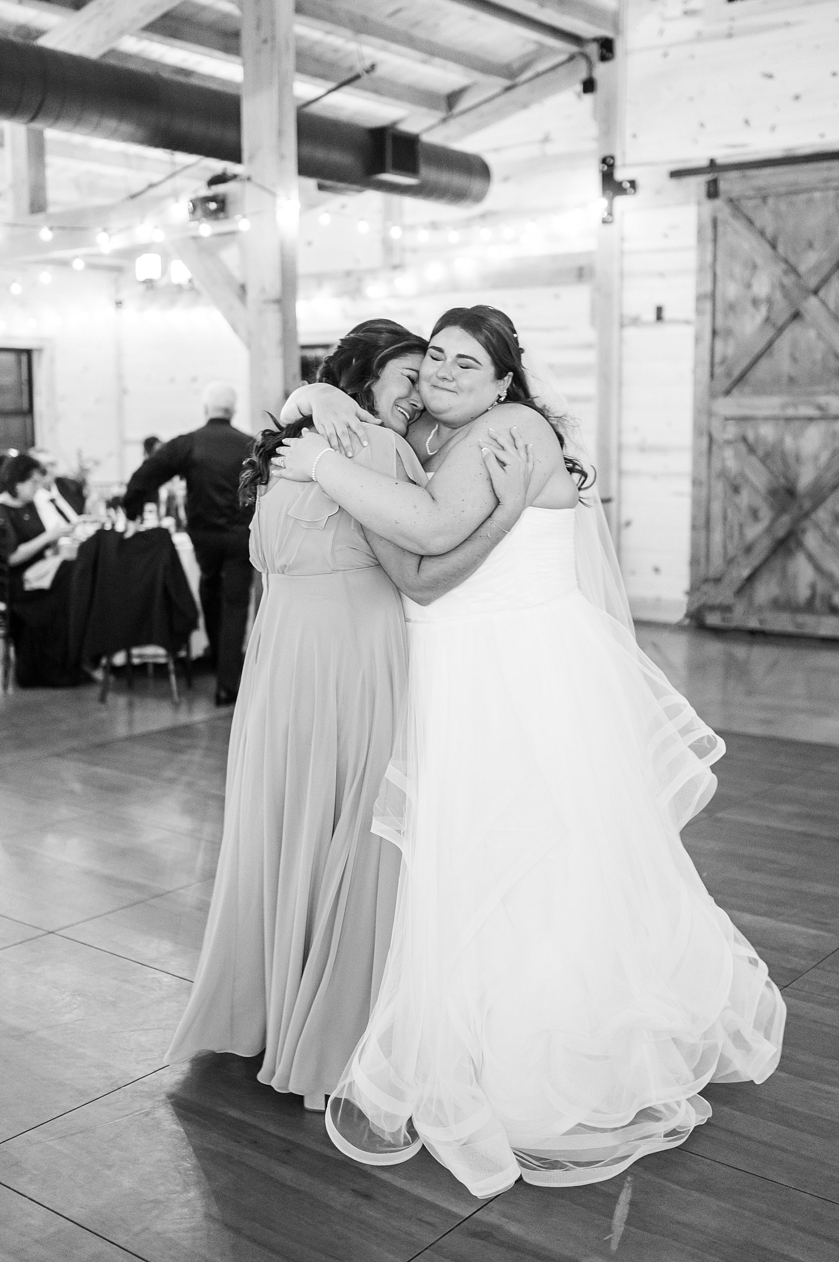 bride hugs her bridesmaid