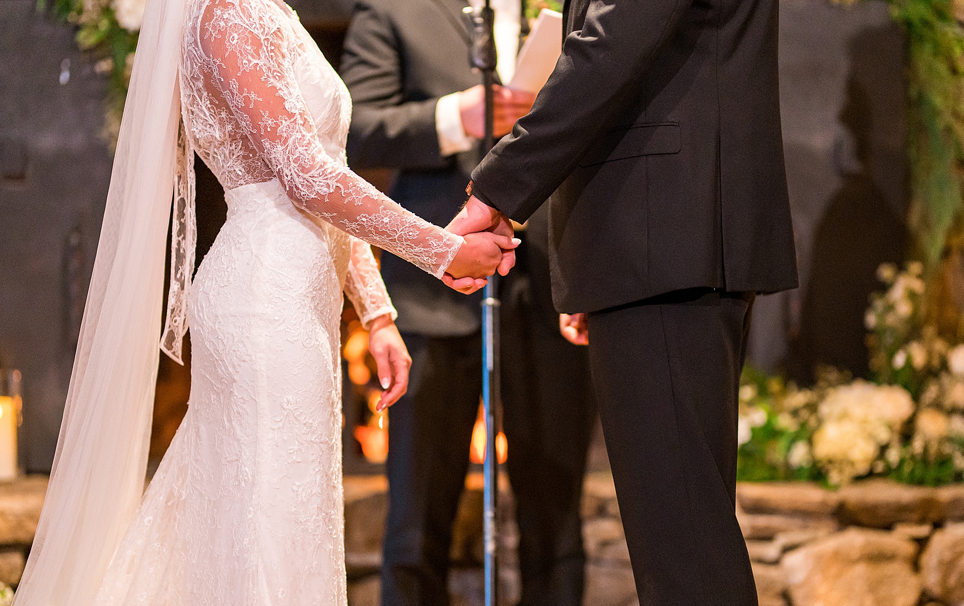 couple holds hands during wedding ceremony 