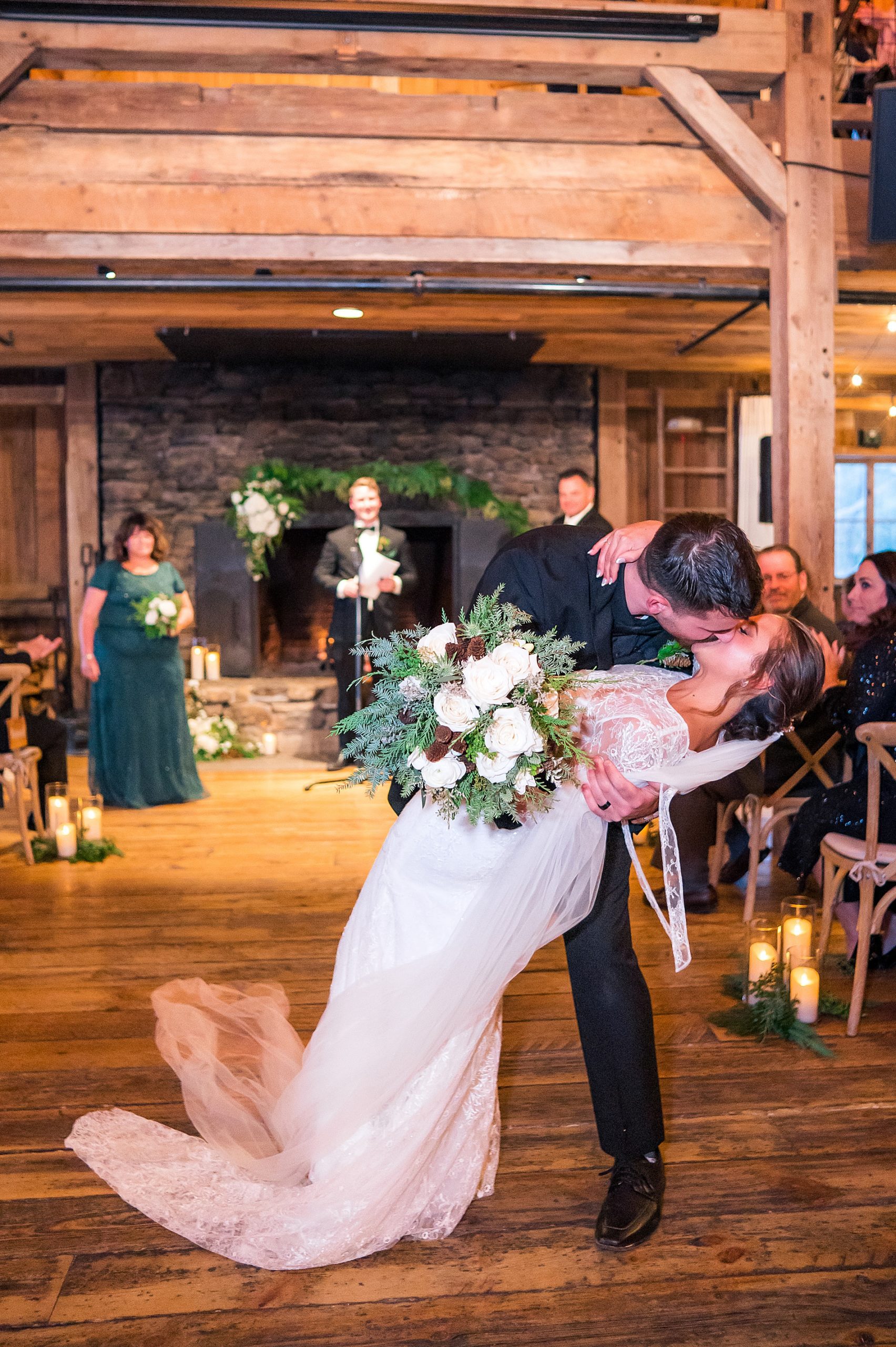 groom dips and kisses his bride during ceremony exit