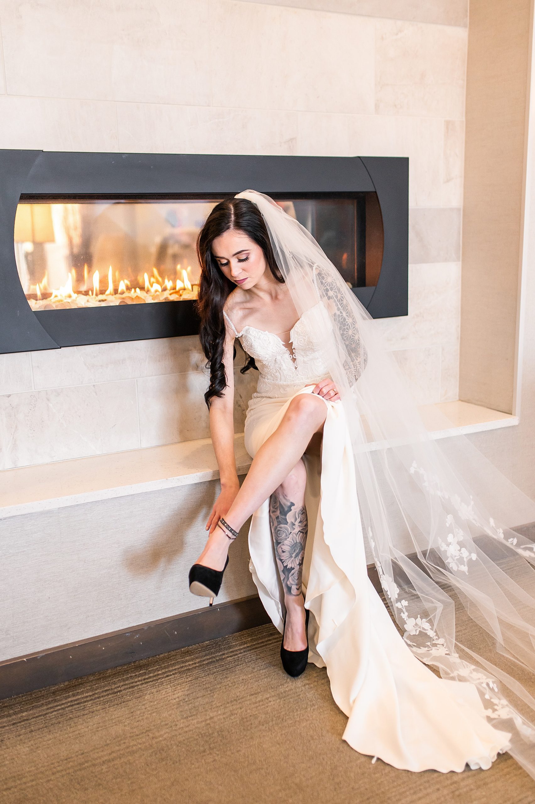 stunning bride puts on black wedding shoes