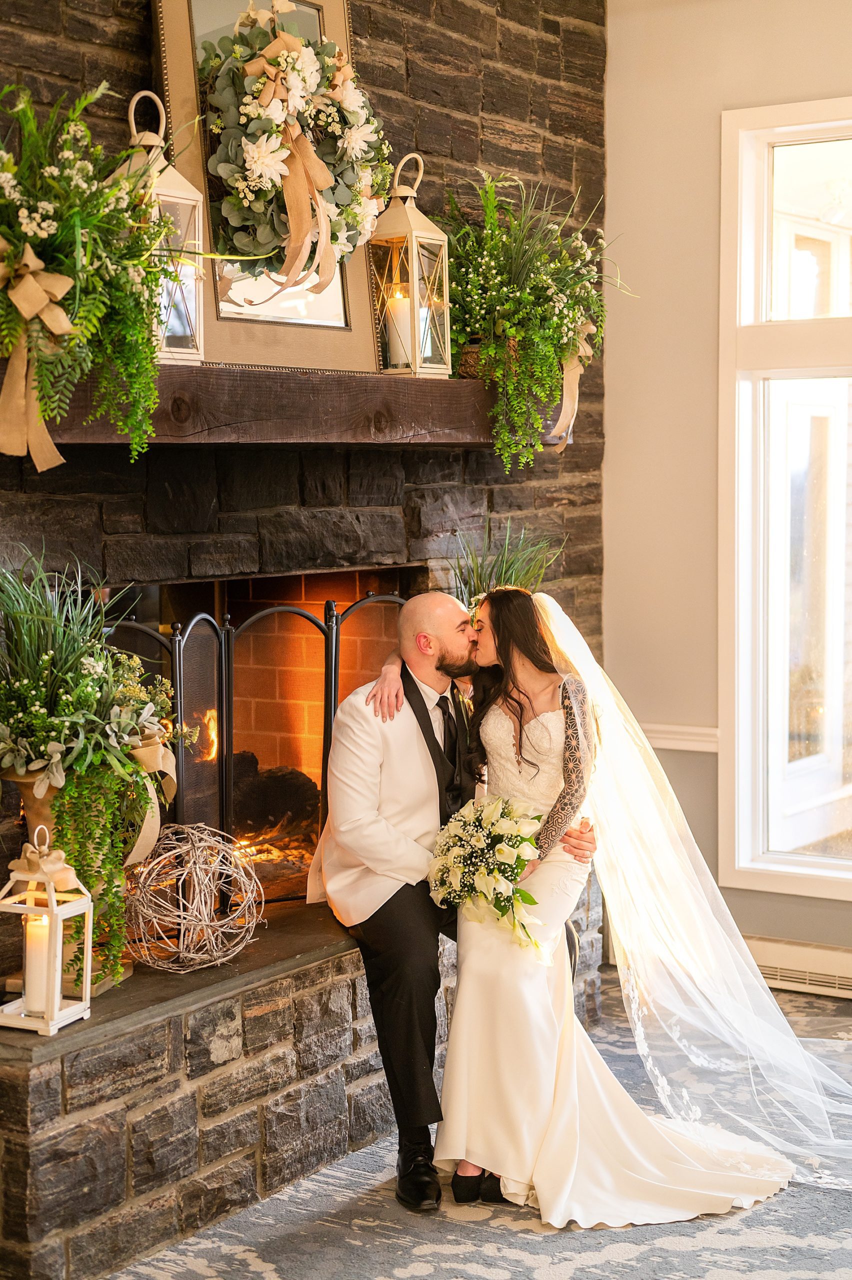 newlyweds sit together by the fireplace at Sky Meadow Country Club