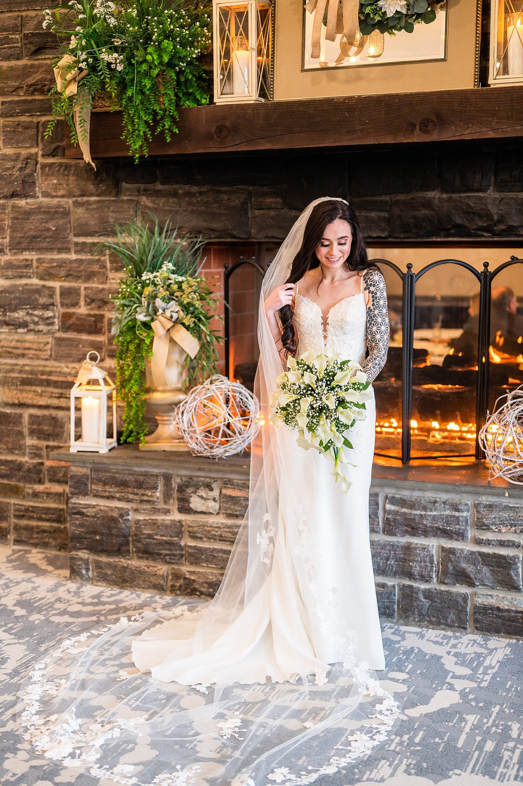 bride shoes off stunning wedding dress and white winter wedding bouquet 