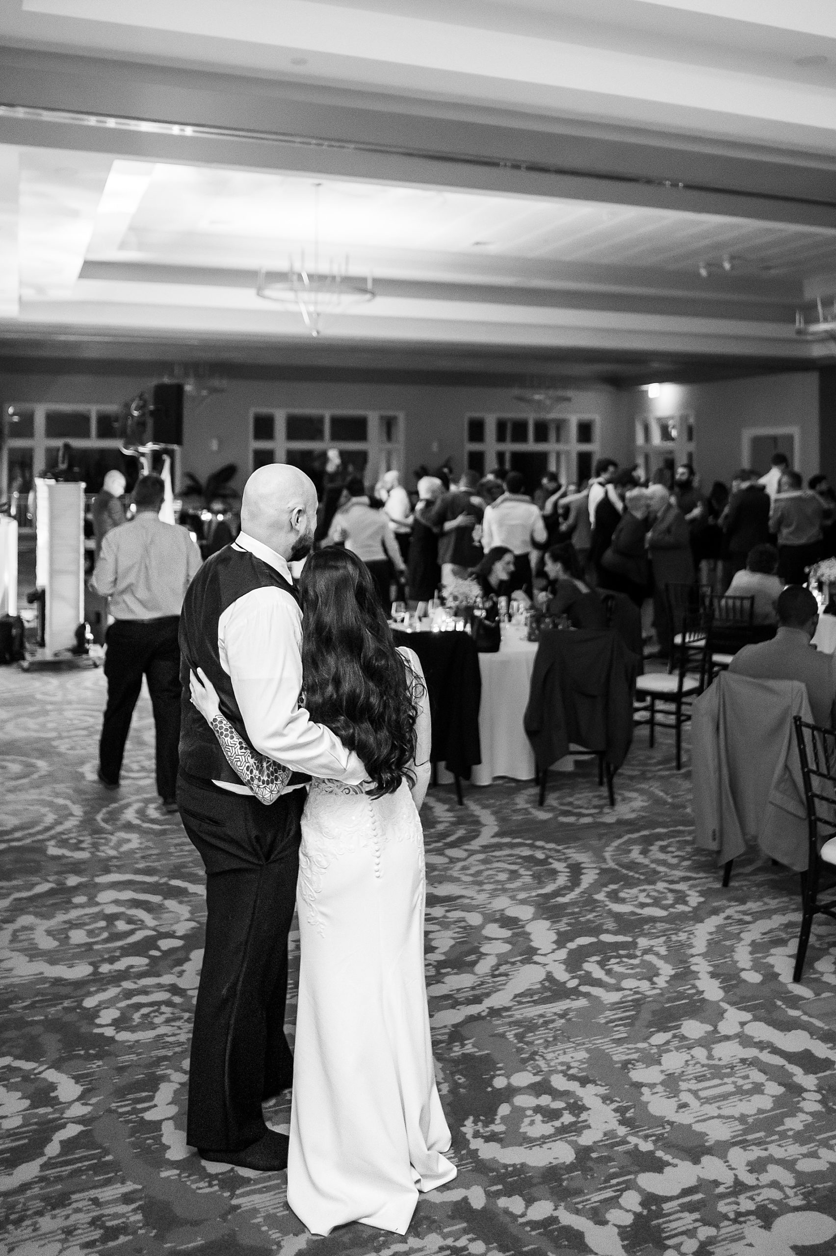 husband and wife stand back and take in their beautiful Classic Winter Wedding day at Sky Meadow Country Club
