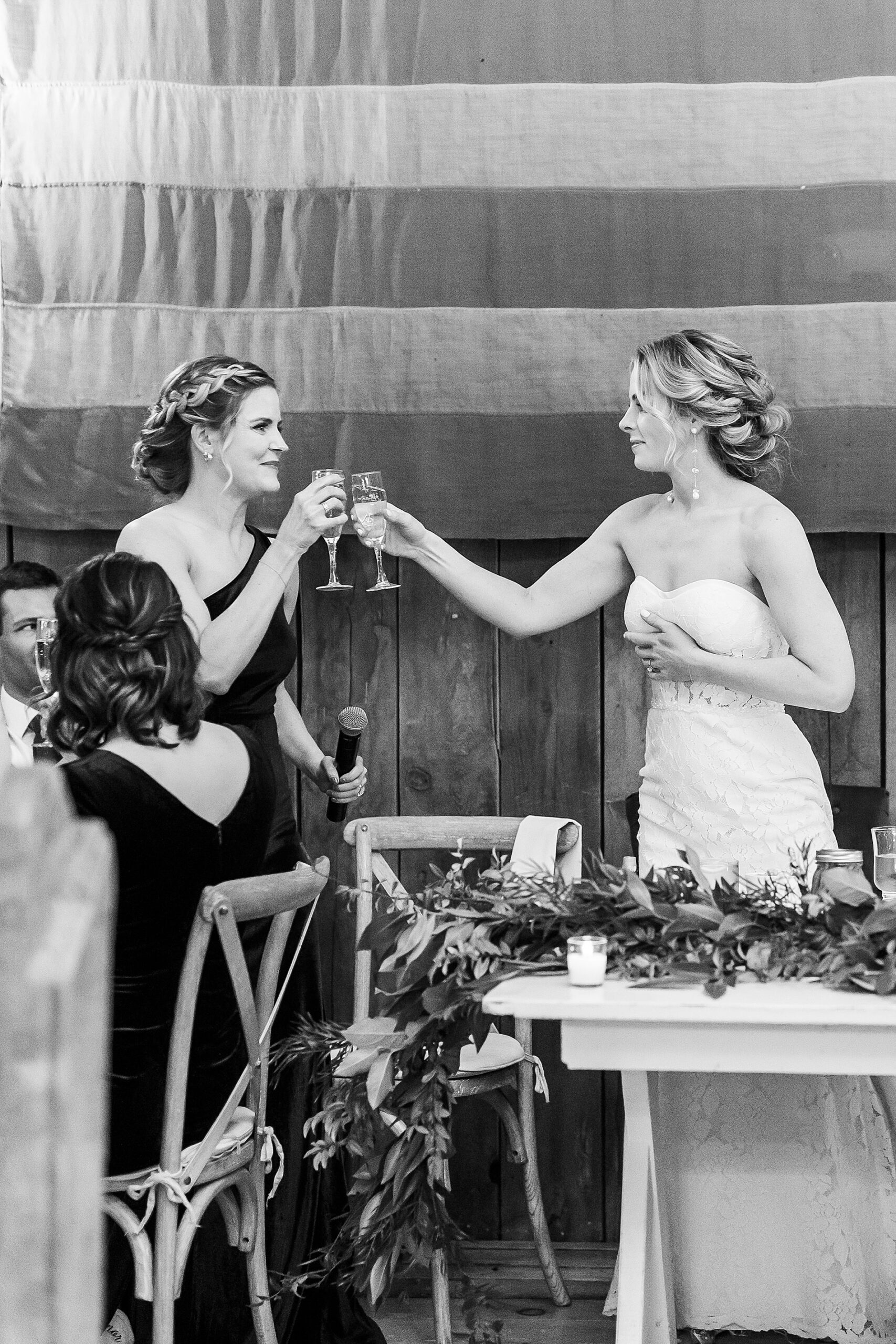 bride toasts with bridesmaid
