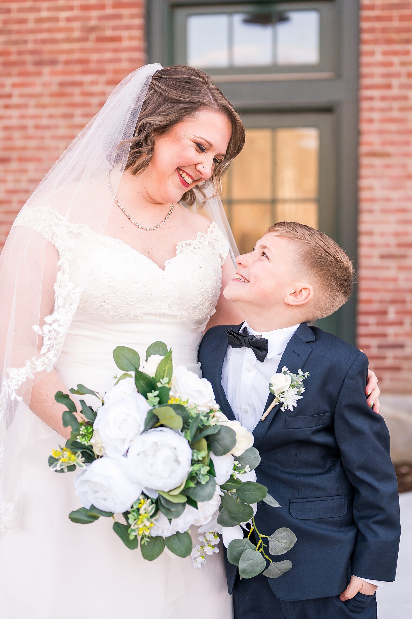 bride with her young son on wedding day