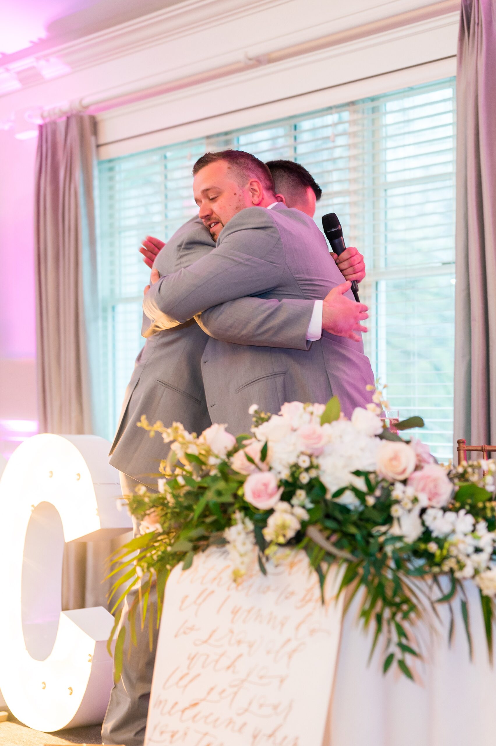 groom hugs best man after speech