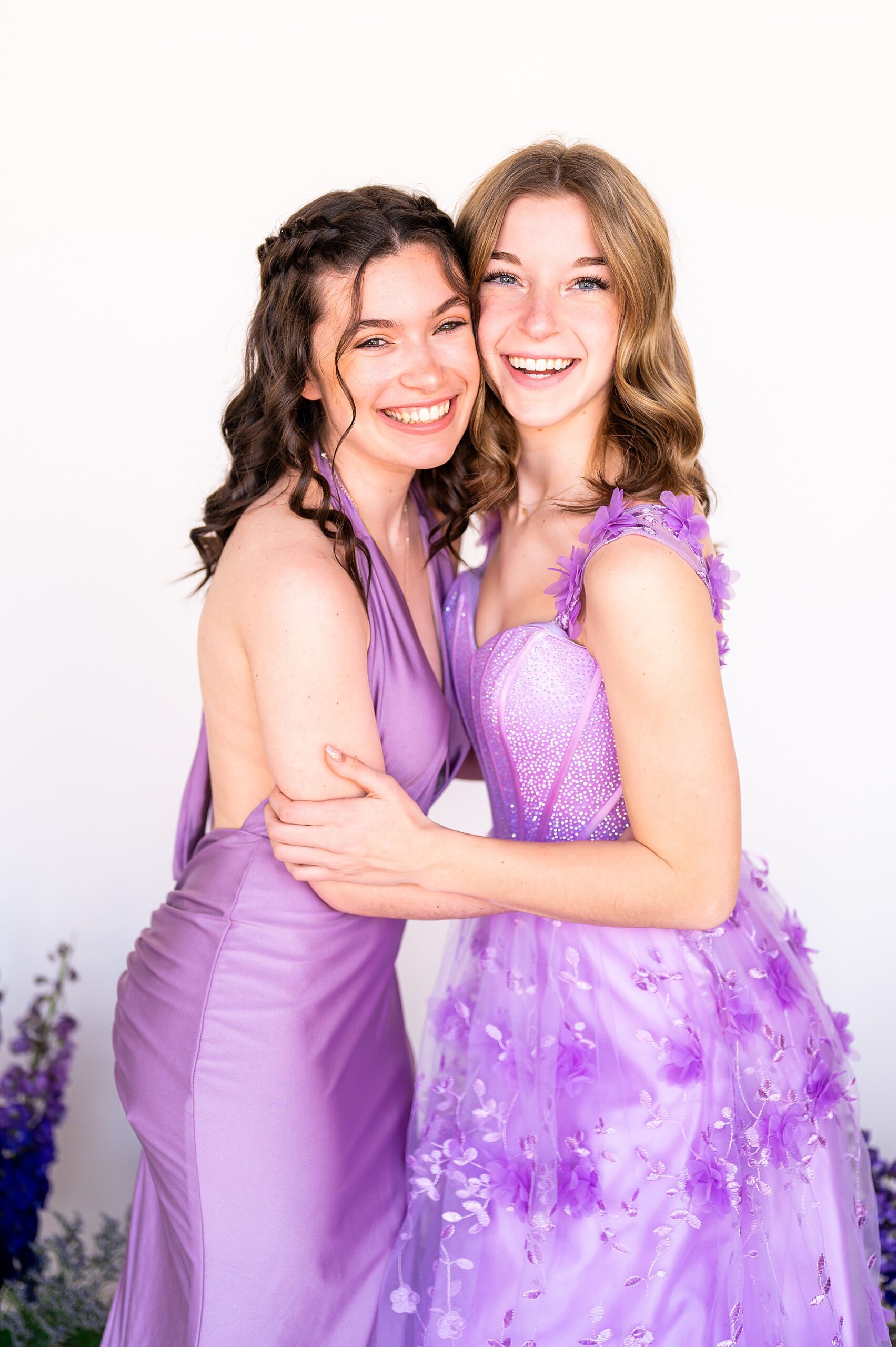 seniors in purple prom dresses during photoshoot at The Social HQ