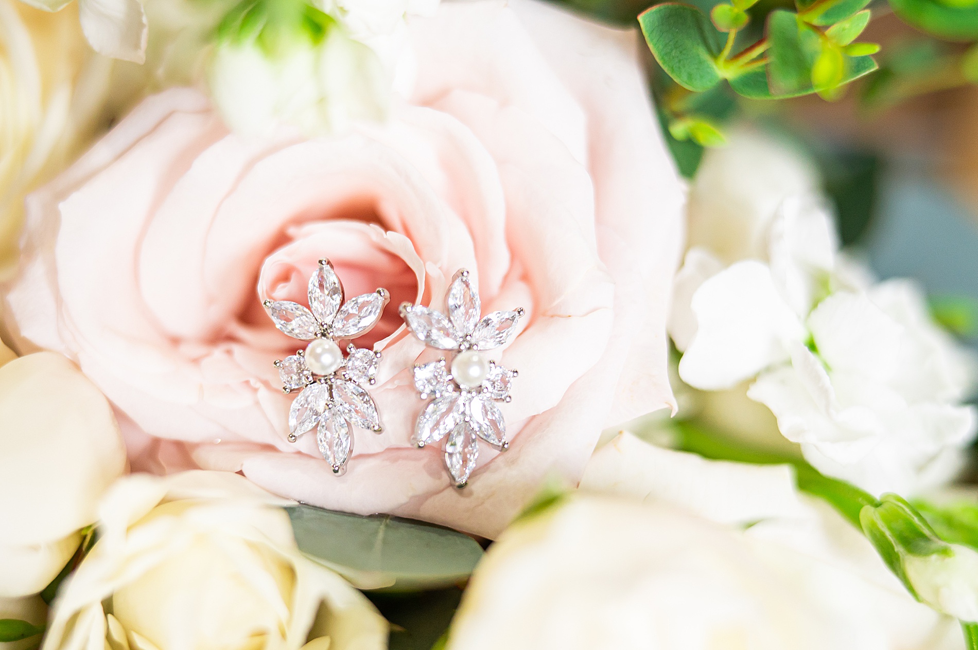 light pink flower with bride's diamond earrings