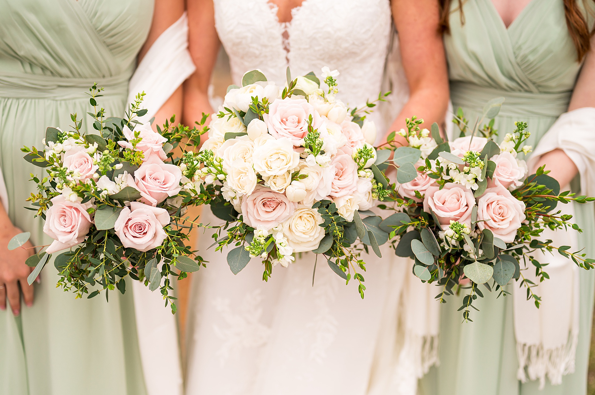 spring wedding bouquets of white and pale pink roses with greenery