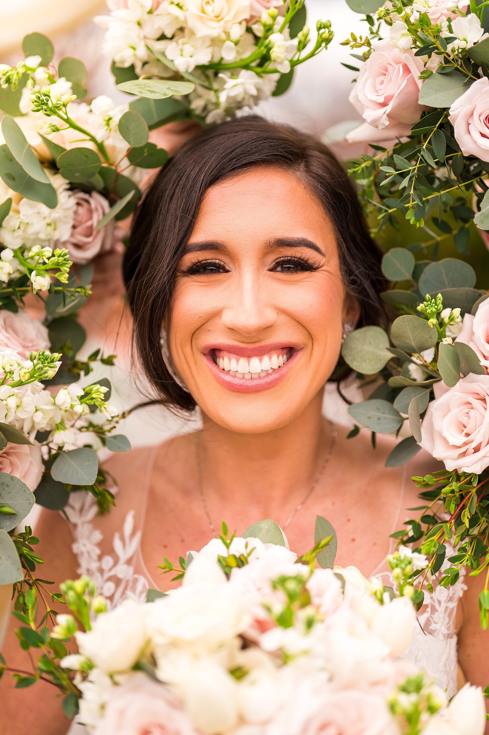 bride surrounded by spring wedding bouquets