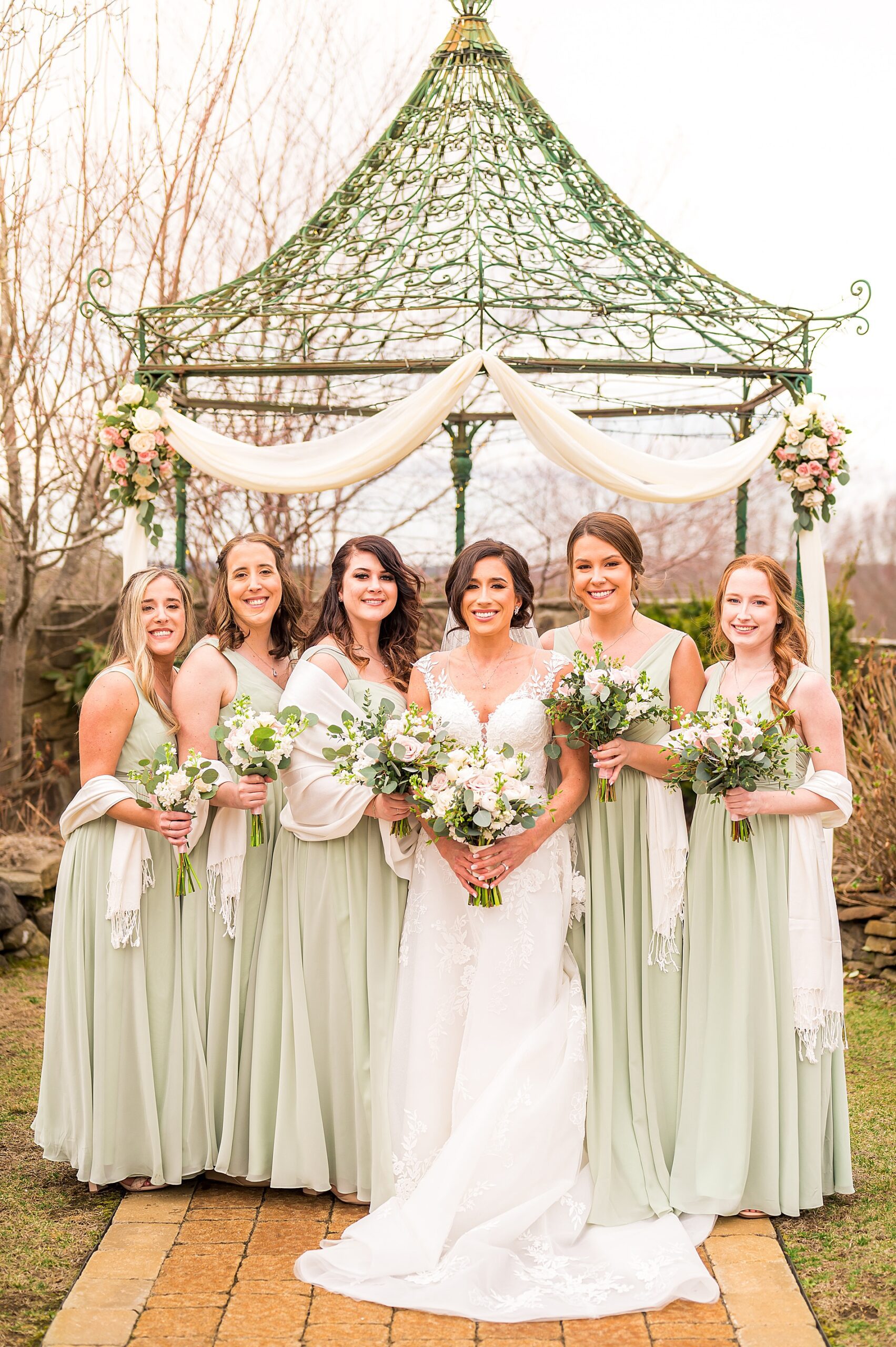 bride with bridesmaids in sage green dresses 
