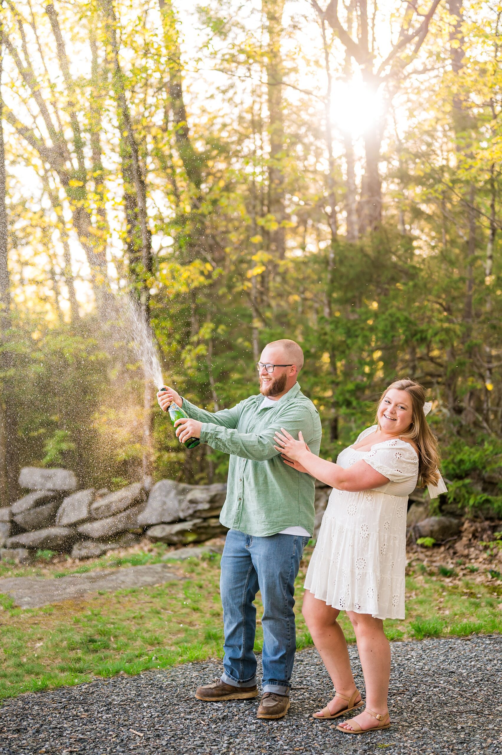 engaged couple celebrate engagement portraits with champagne