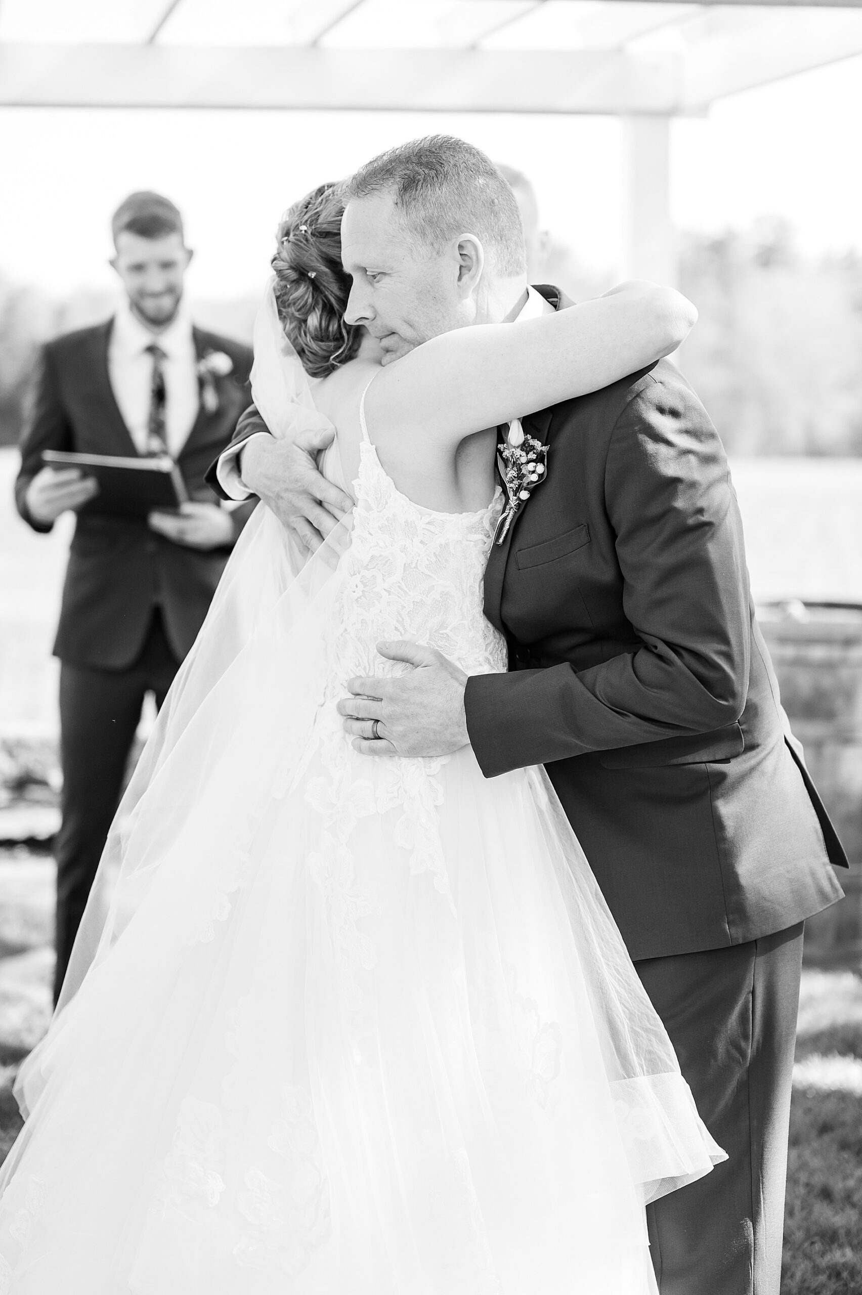 bride hugs her father at wedding ceremony 