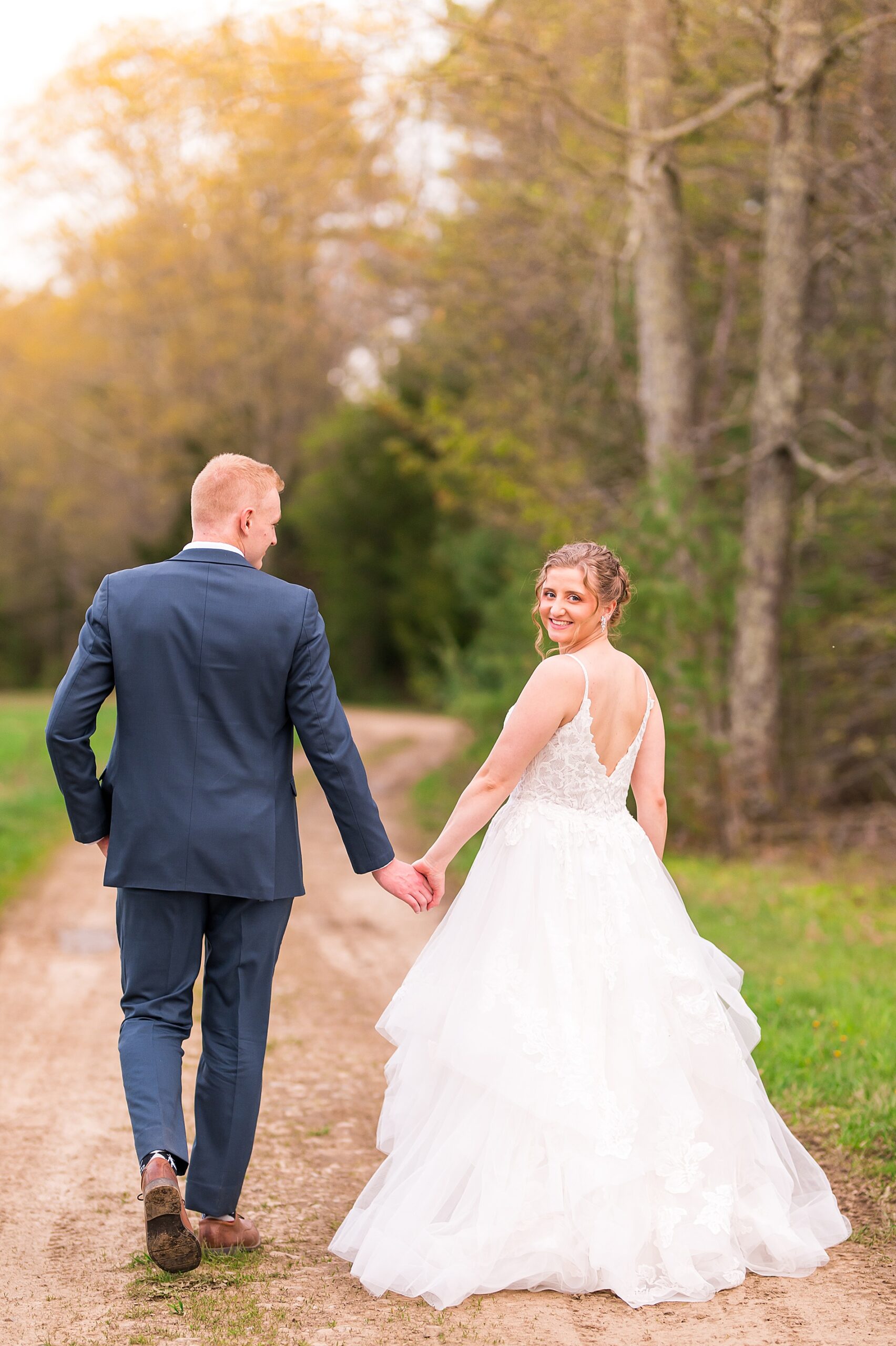 newlyweds walk together hand in hand 