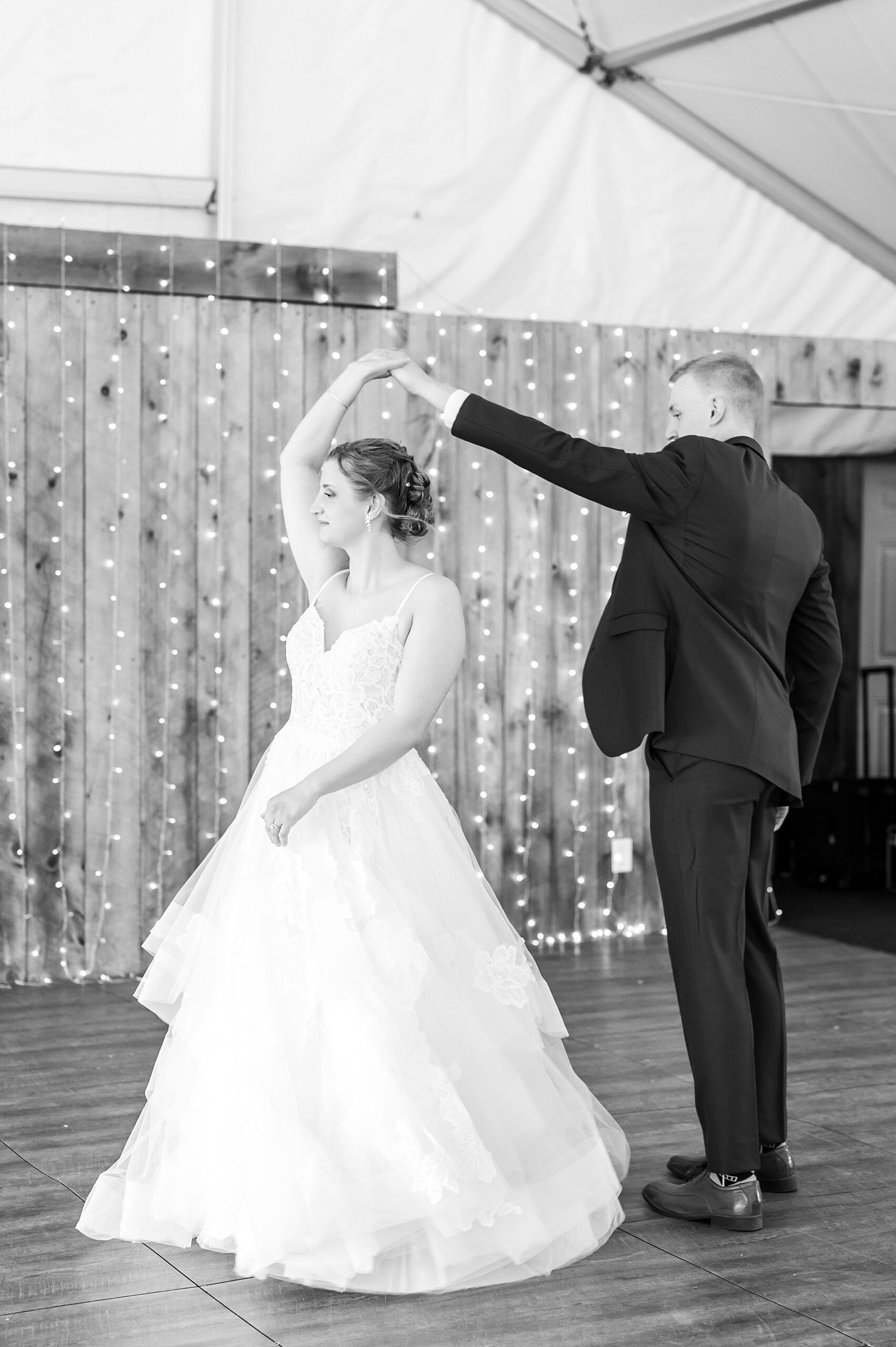 groom twirls bride during first dance