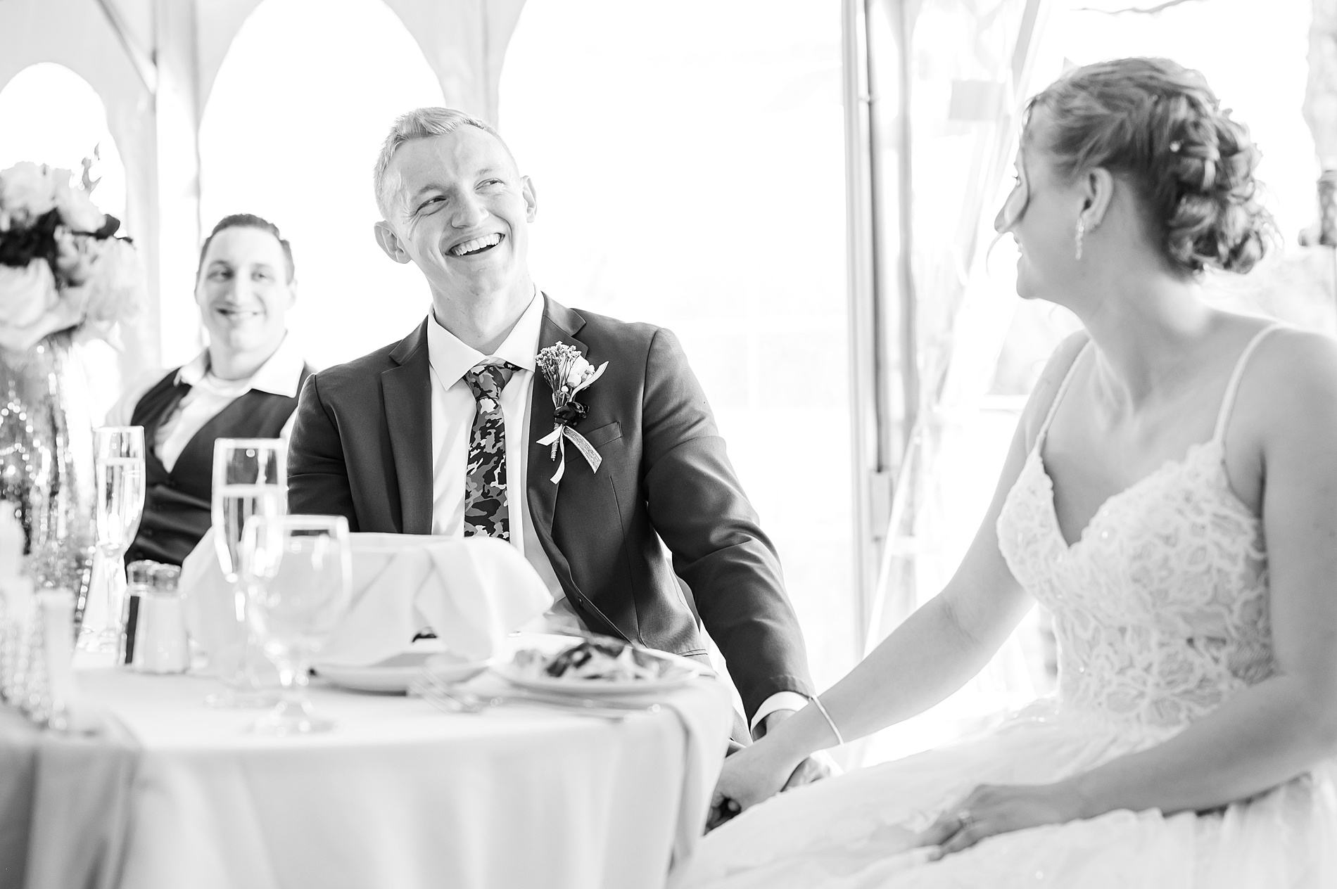 couple listen to wedding toasts at reception 