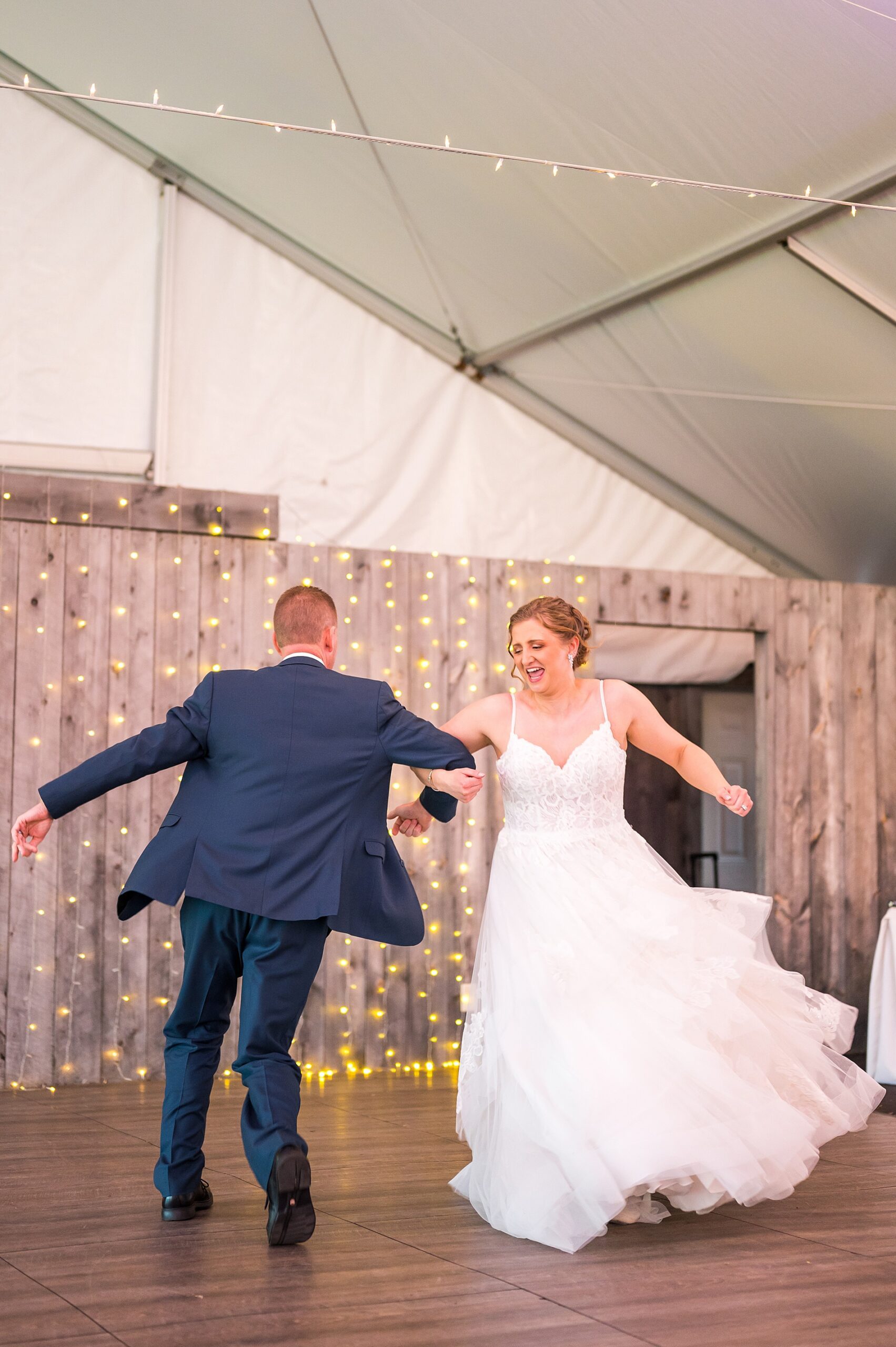 bride and her father swing around during their choreographed father-daughter dance