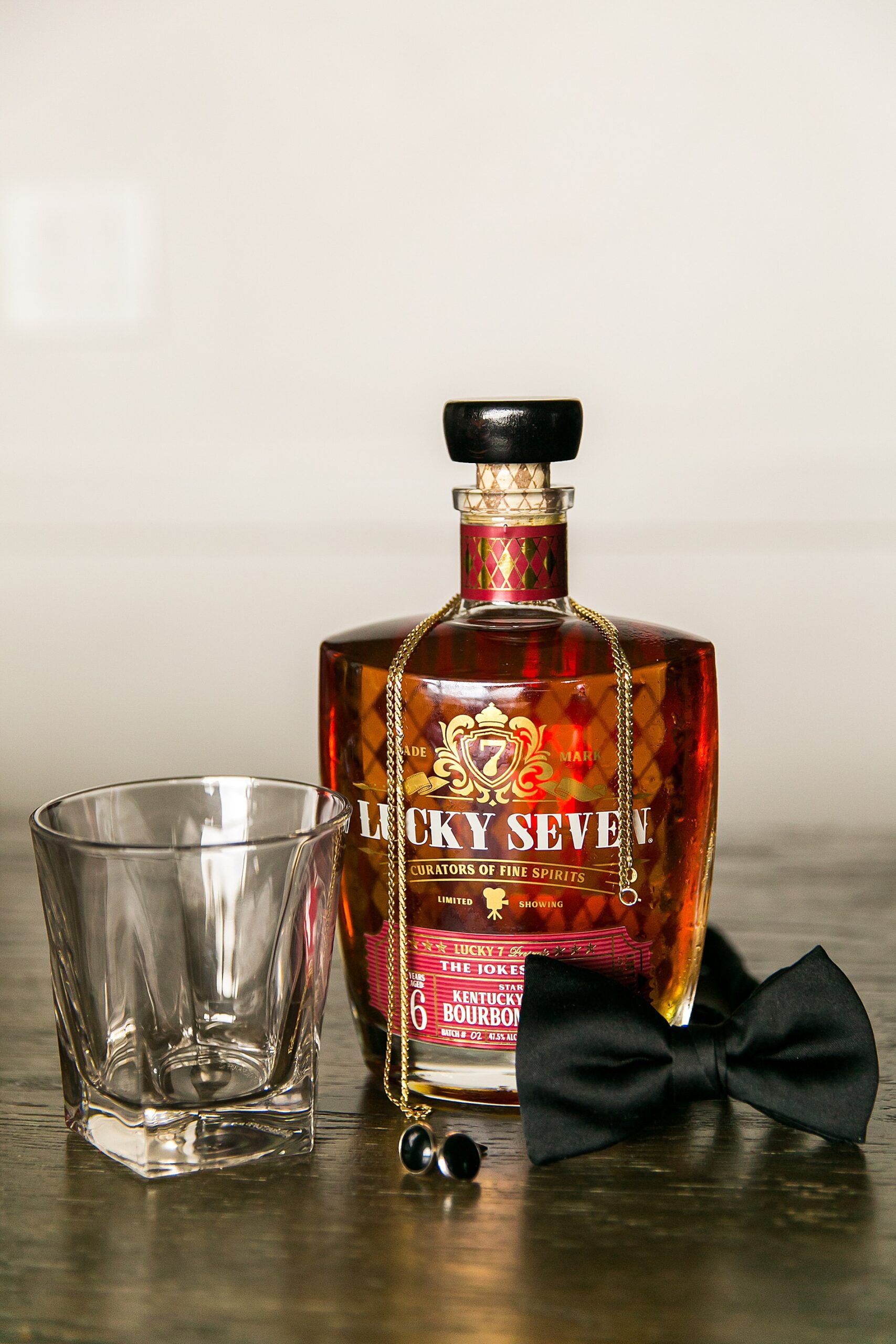 groom details with bowtie and bourbon 
