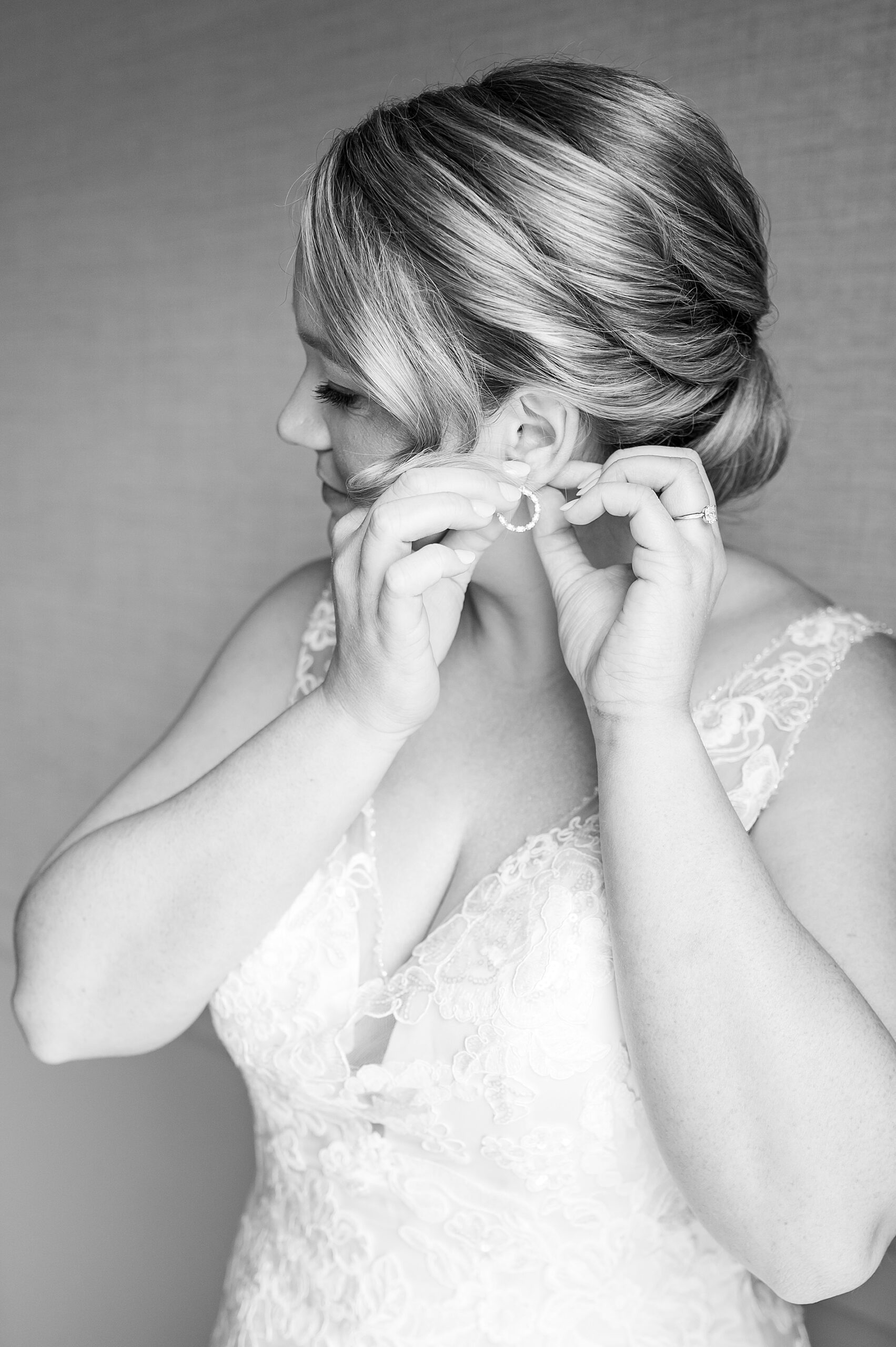 bride puts earrings in and gets ready for Spring Wedding at Church Landing