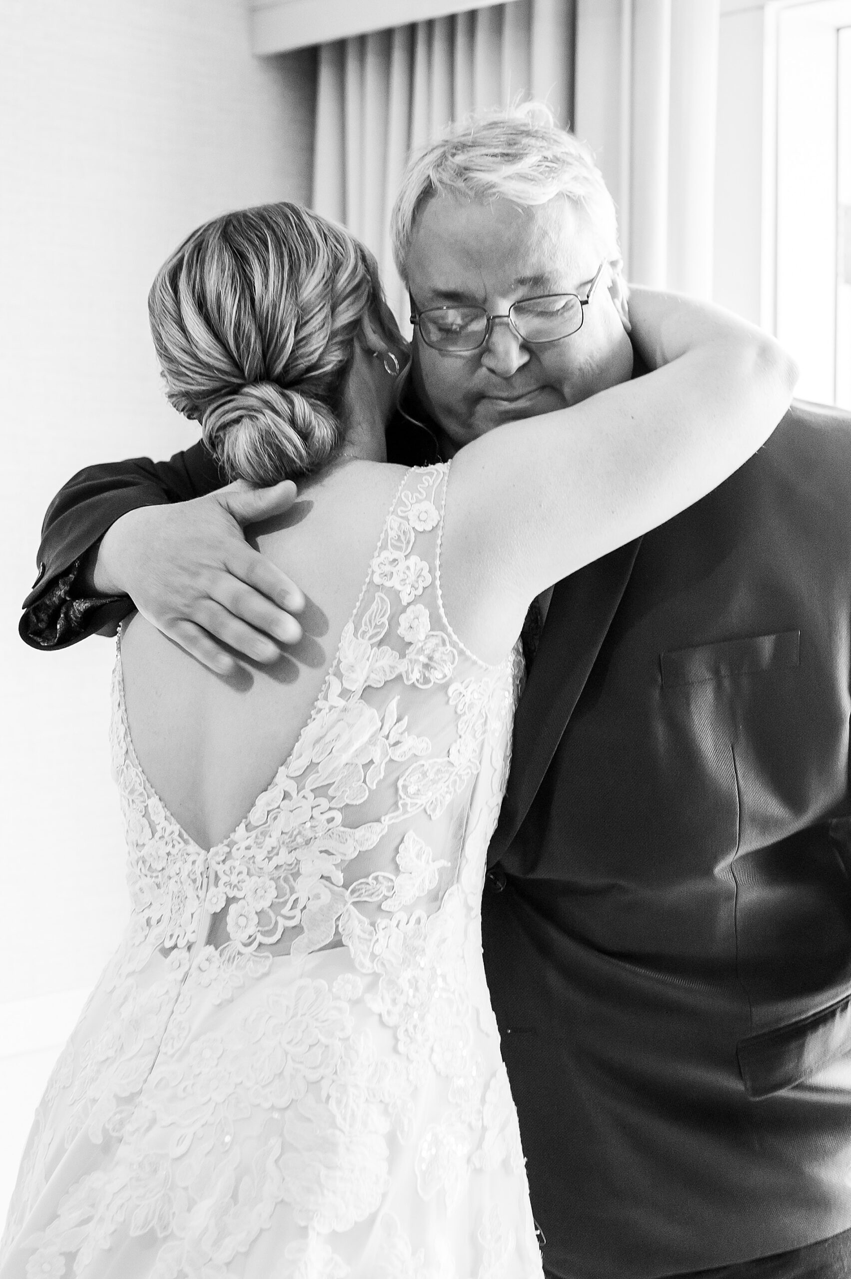 bride hugs father during first look