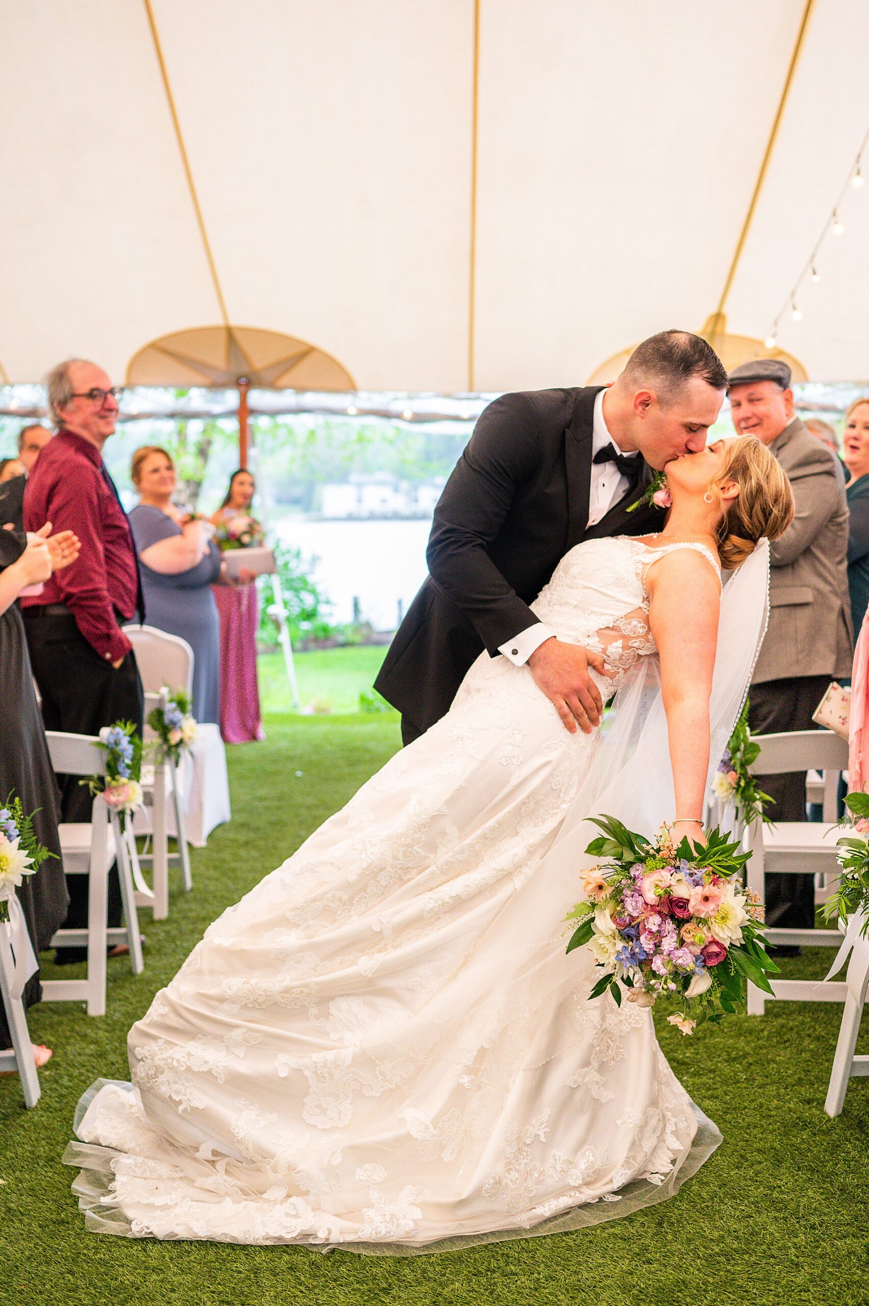 newlyweds kiss as they walk down the aisle as husband and wife 