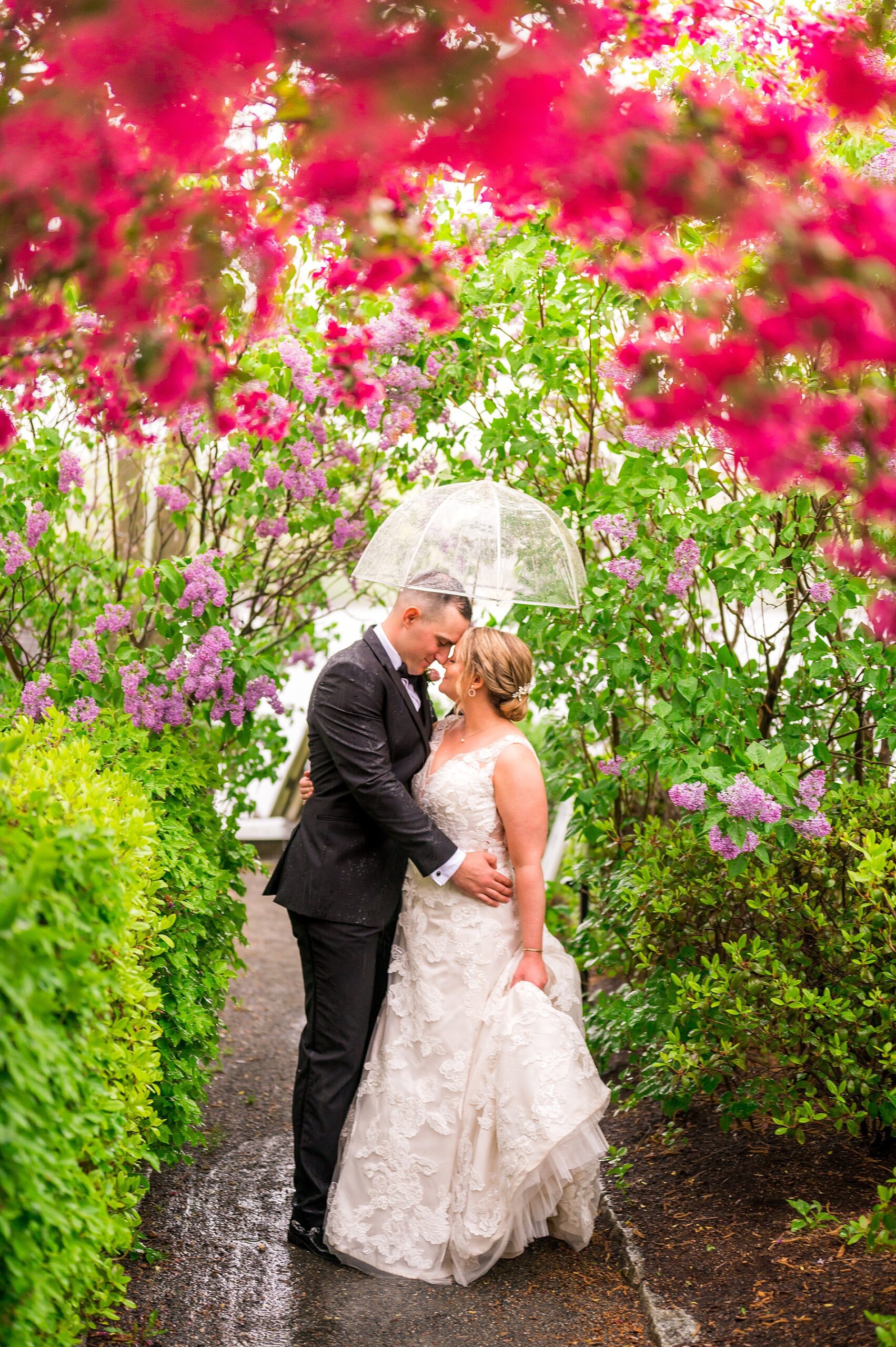spring wedding portraits surrounded by pink and purple flowers