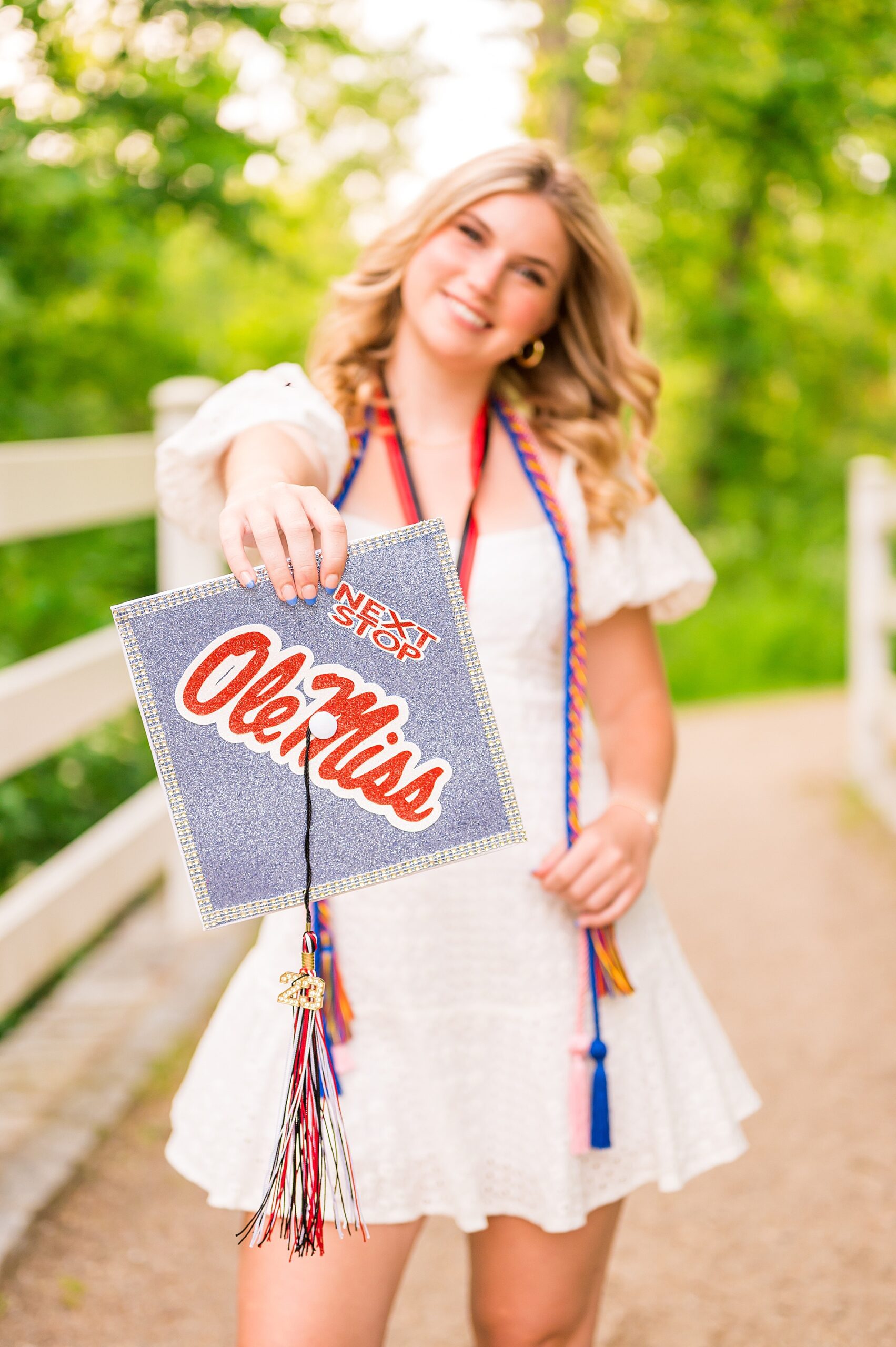 senior holds cap with Ole Miss on it