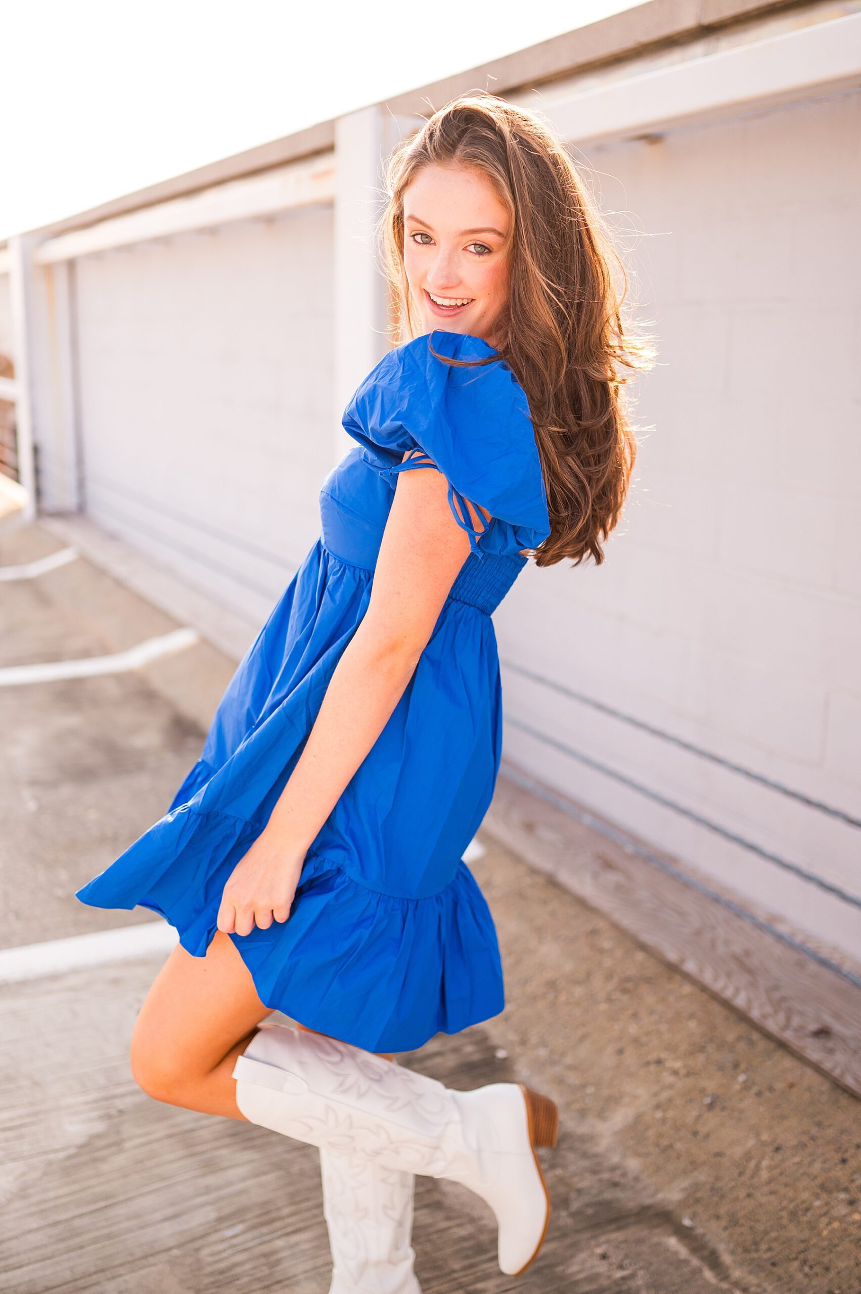 senior girl in blue dress and white cowboy boots