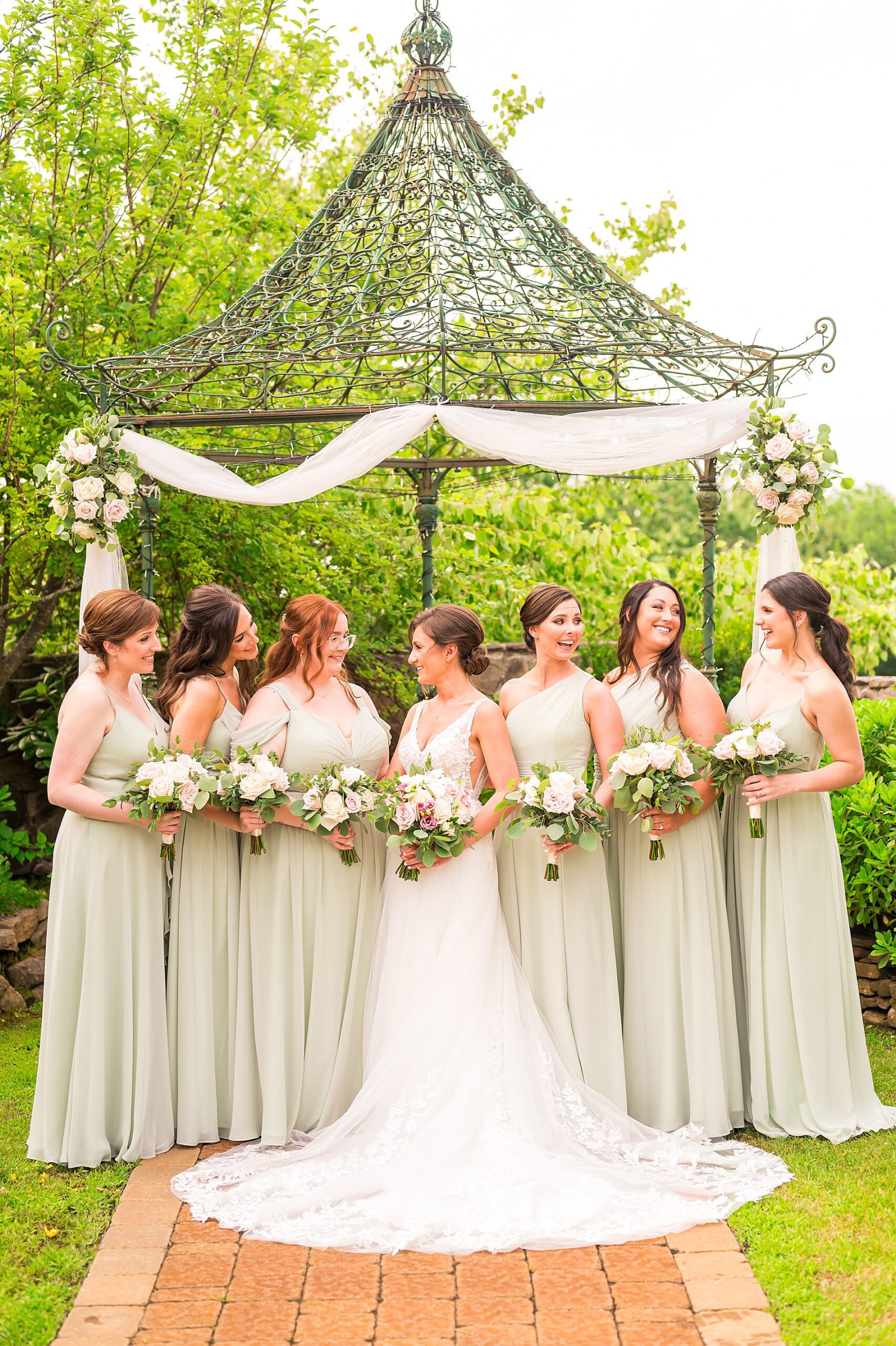 bride with bridesmaids in sage green dresses