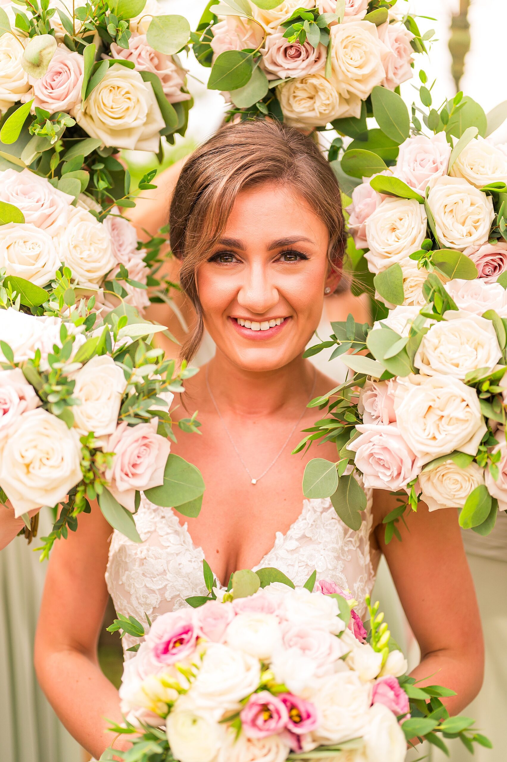 bride surrounded by summer wedding bouquets 