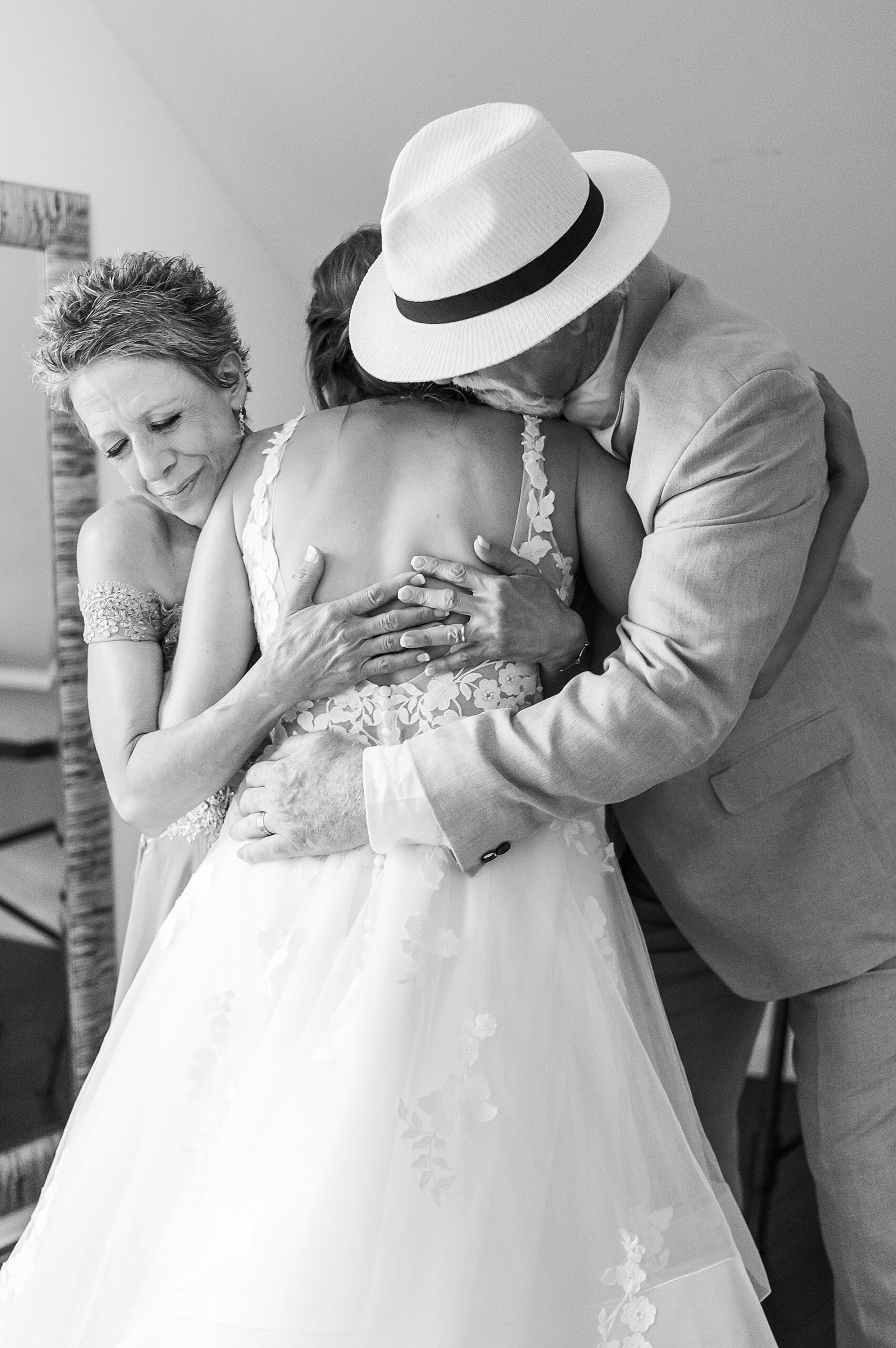 parents hug their daughter during first look