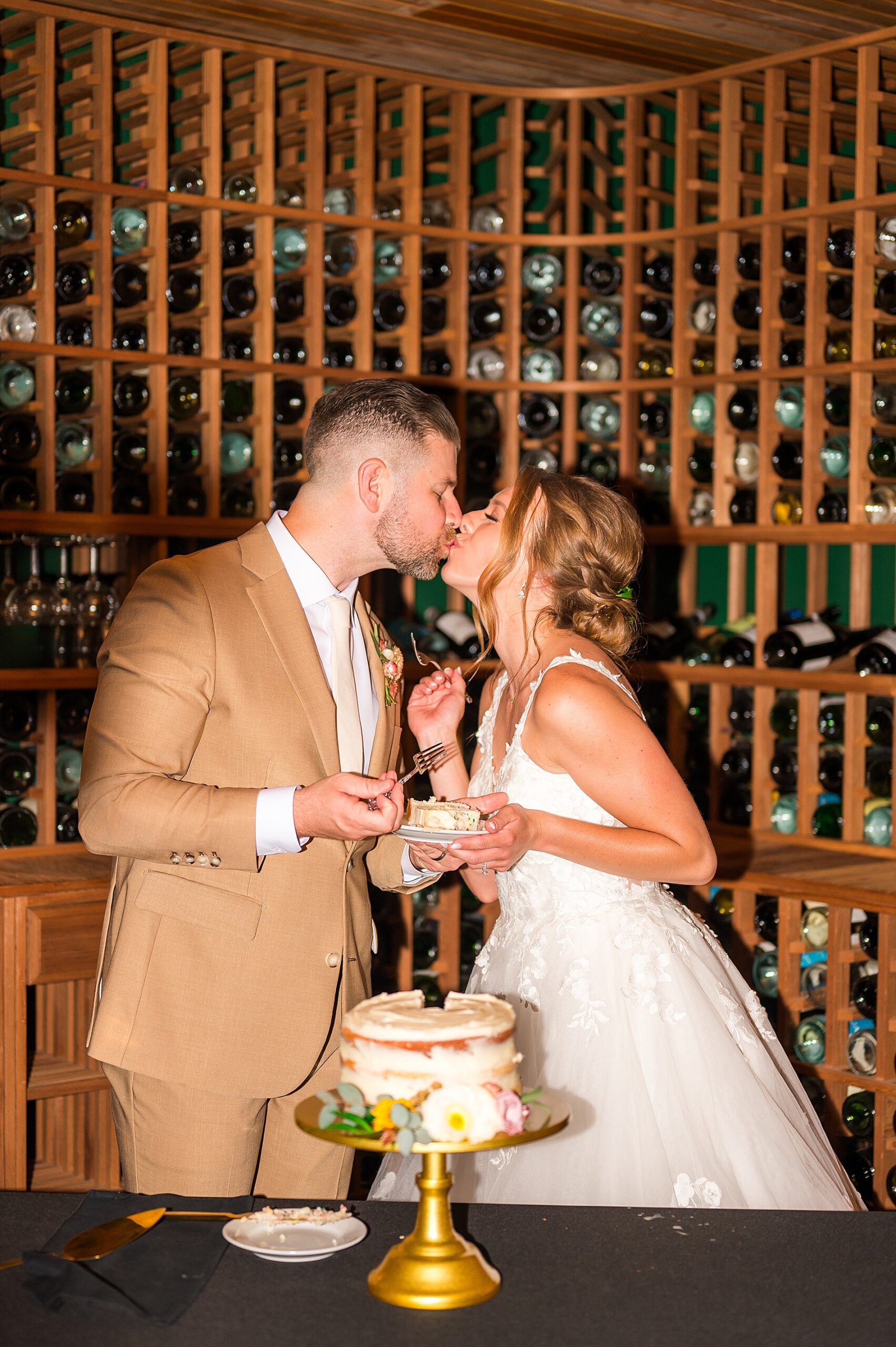 newlyweds kiss during cake cutting