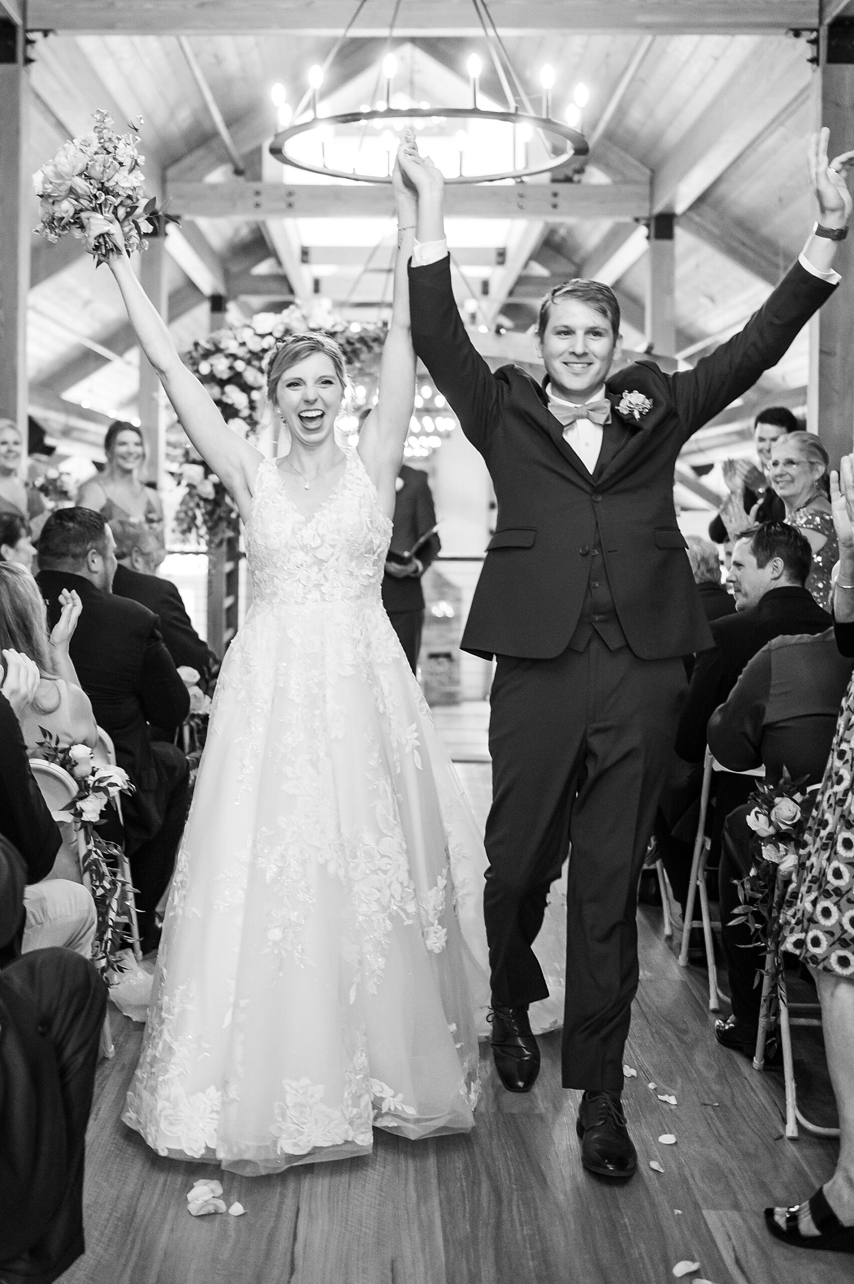 newlyweds celebrate as they exit wedding ceremony 