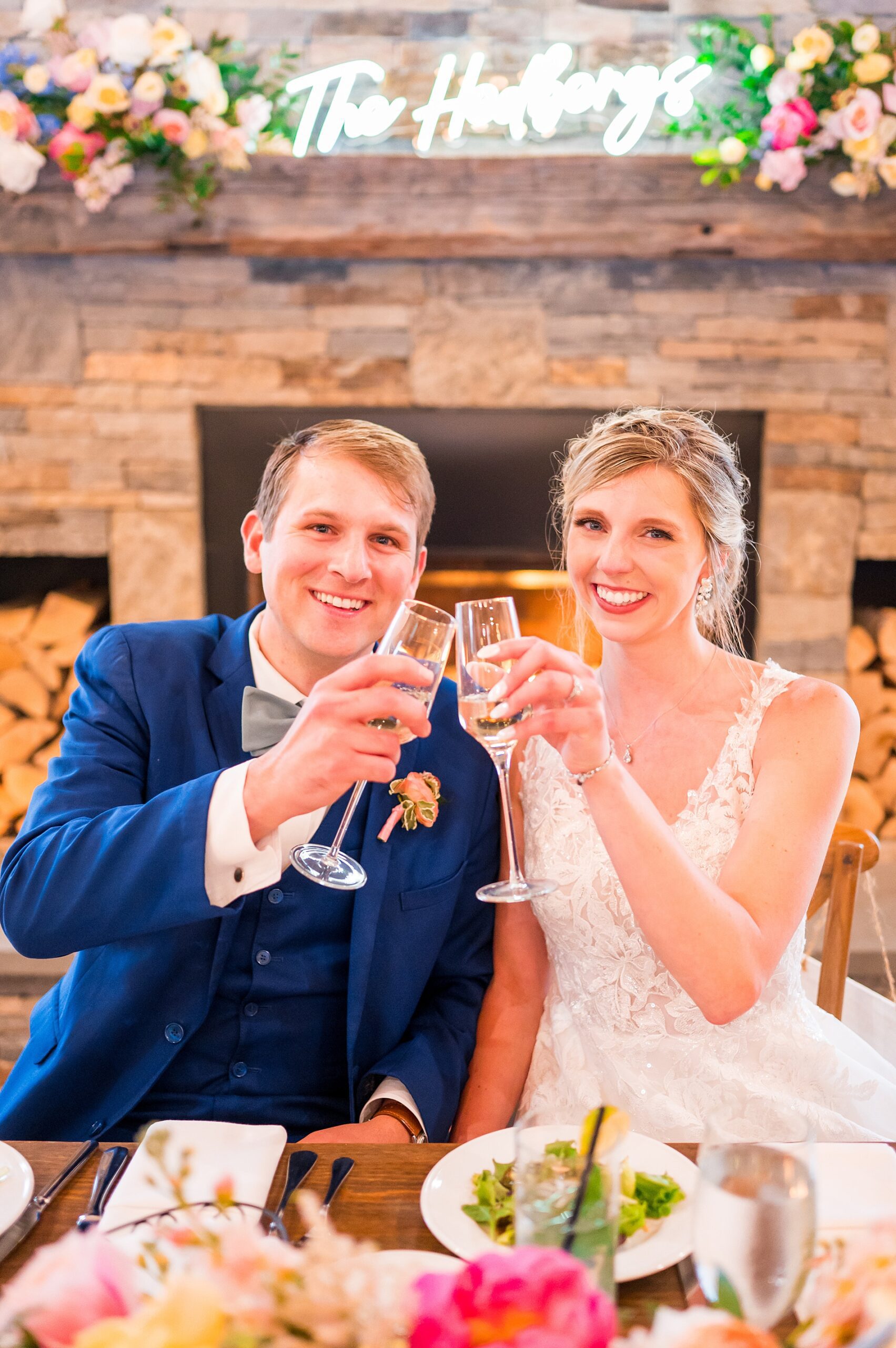 newlyweds toast their champagne glasses at Summer Wedding at Owl's Nest Resort  