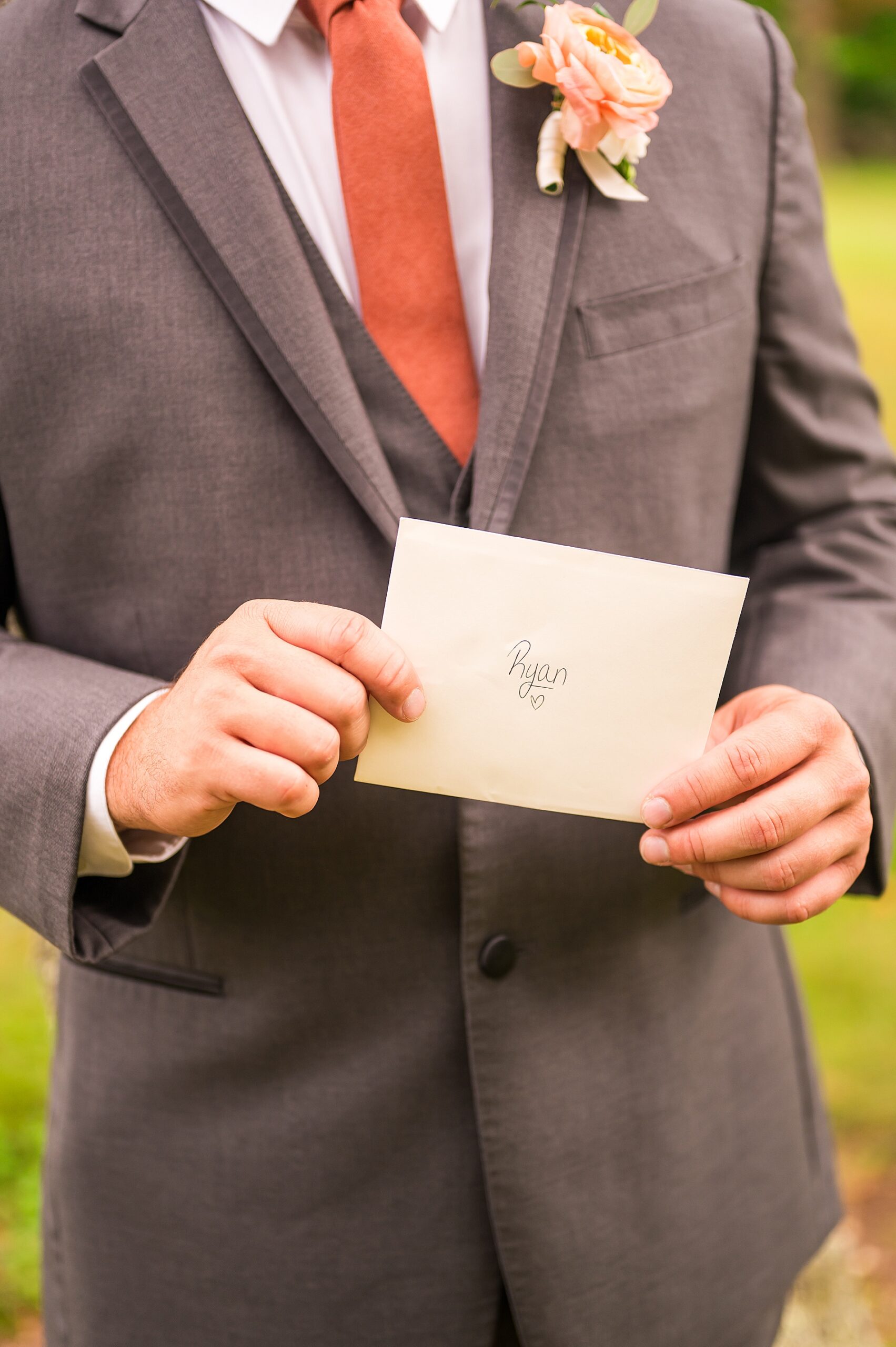 groom holds letter from bride