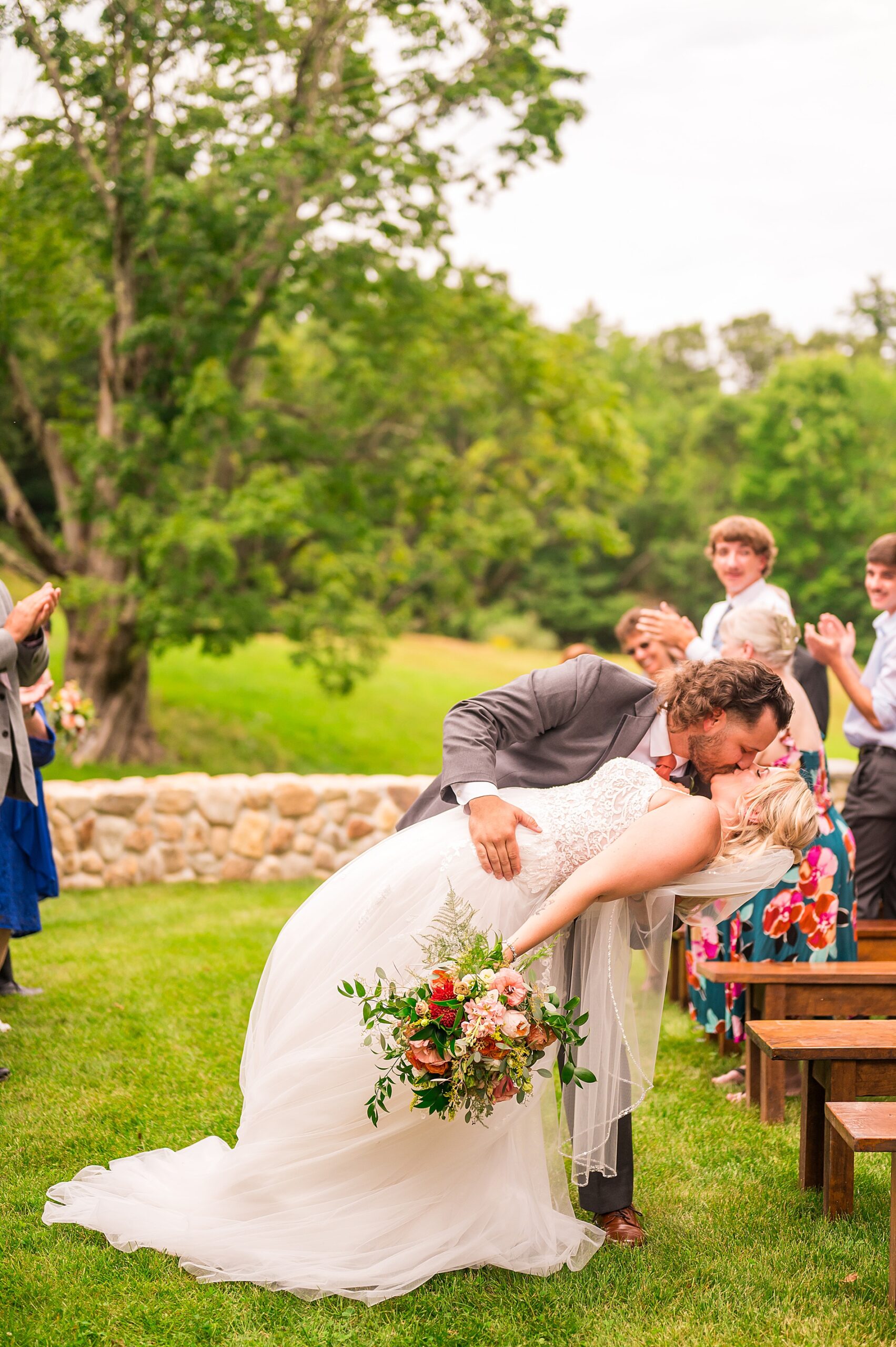 groom dips his bride for a kiss