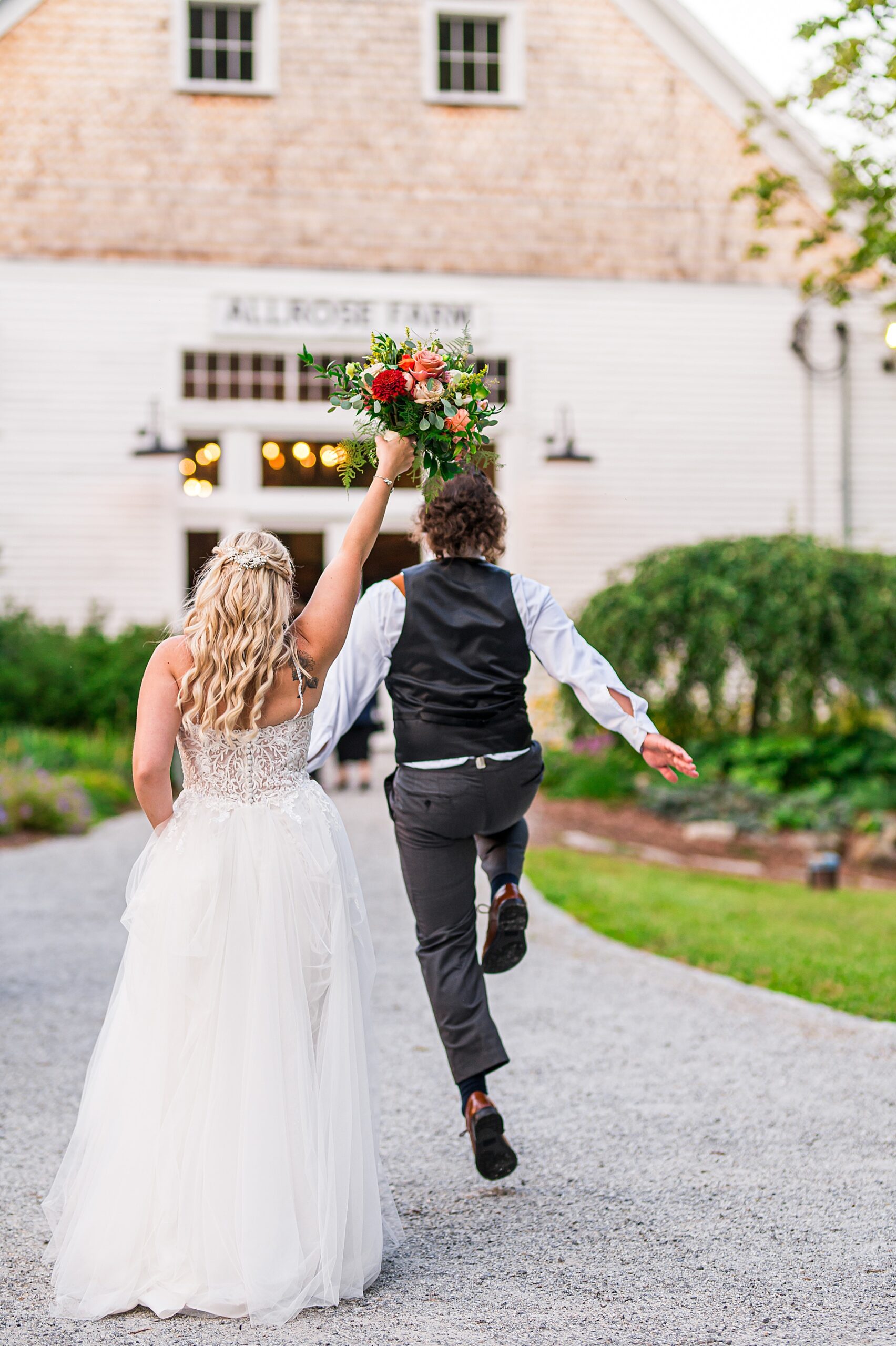 excited newlyweds walk into Allrose Farm Wedding reception