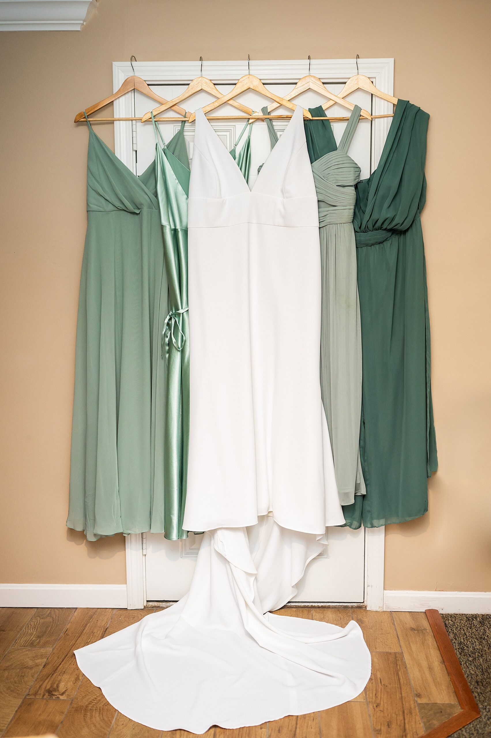 wedding dress and bridesmaids dresses in shades of sage green
