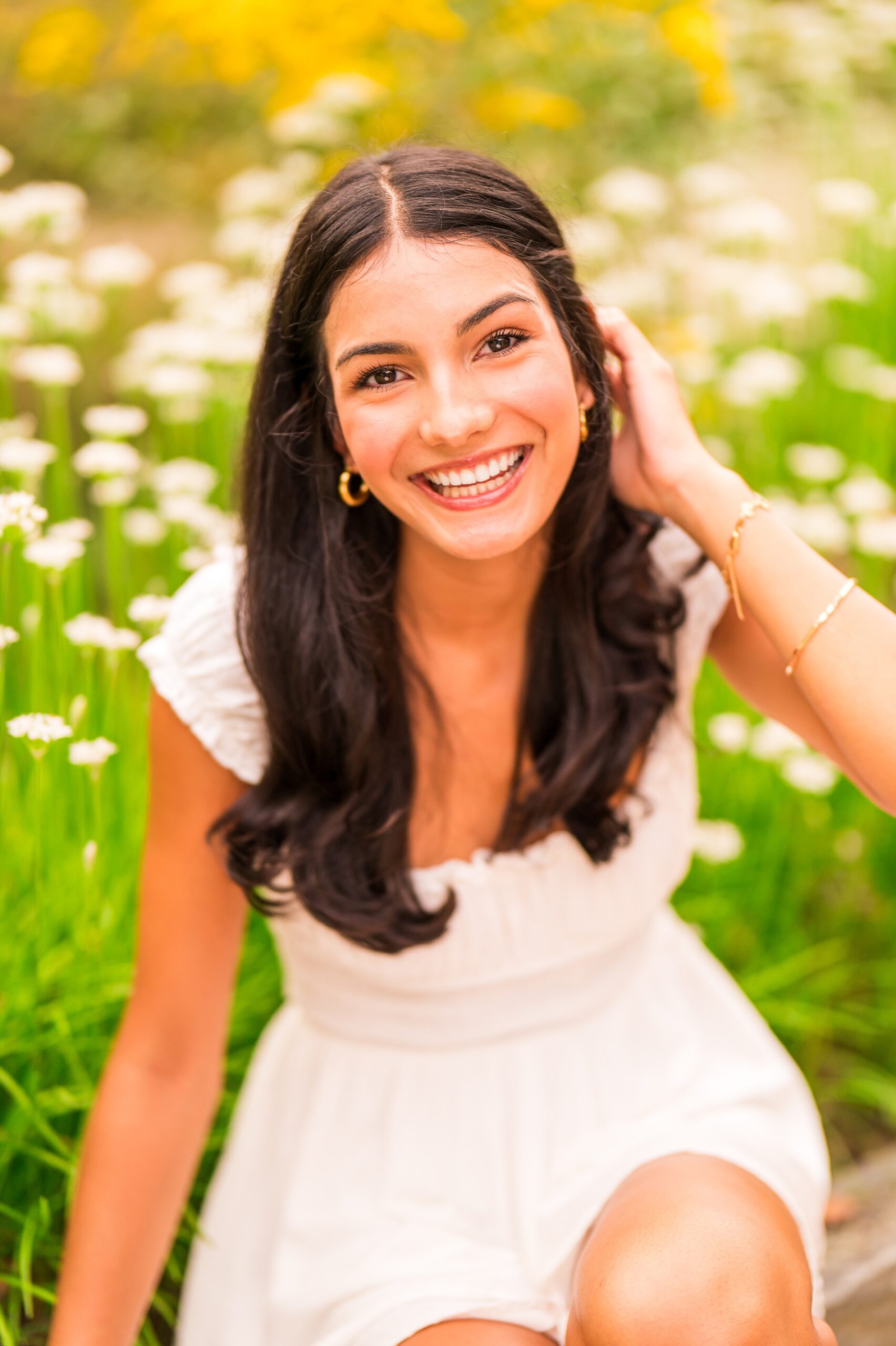 senior girl in field of flowers during Southern New Hampshire Summer Senior Sessions