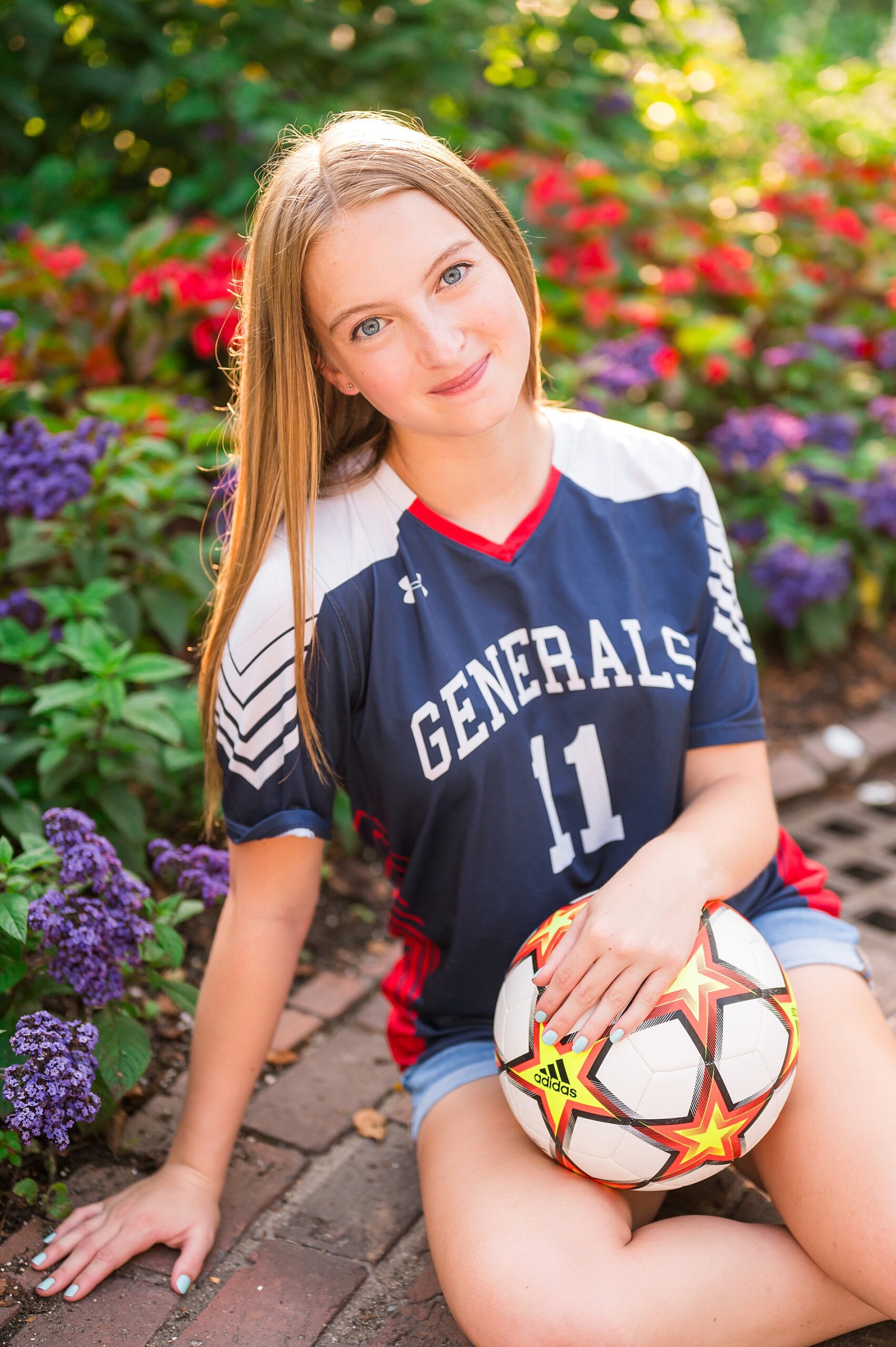 senior high school athlete sits with soccer ball for Summer Senior Sessions