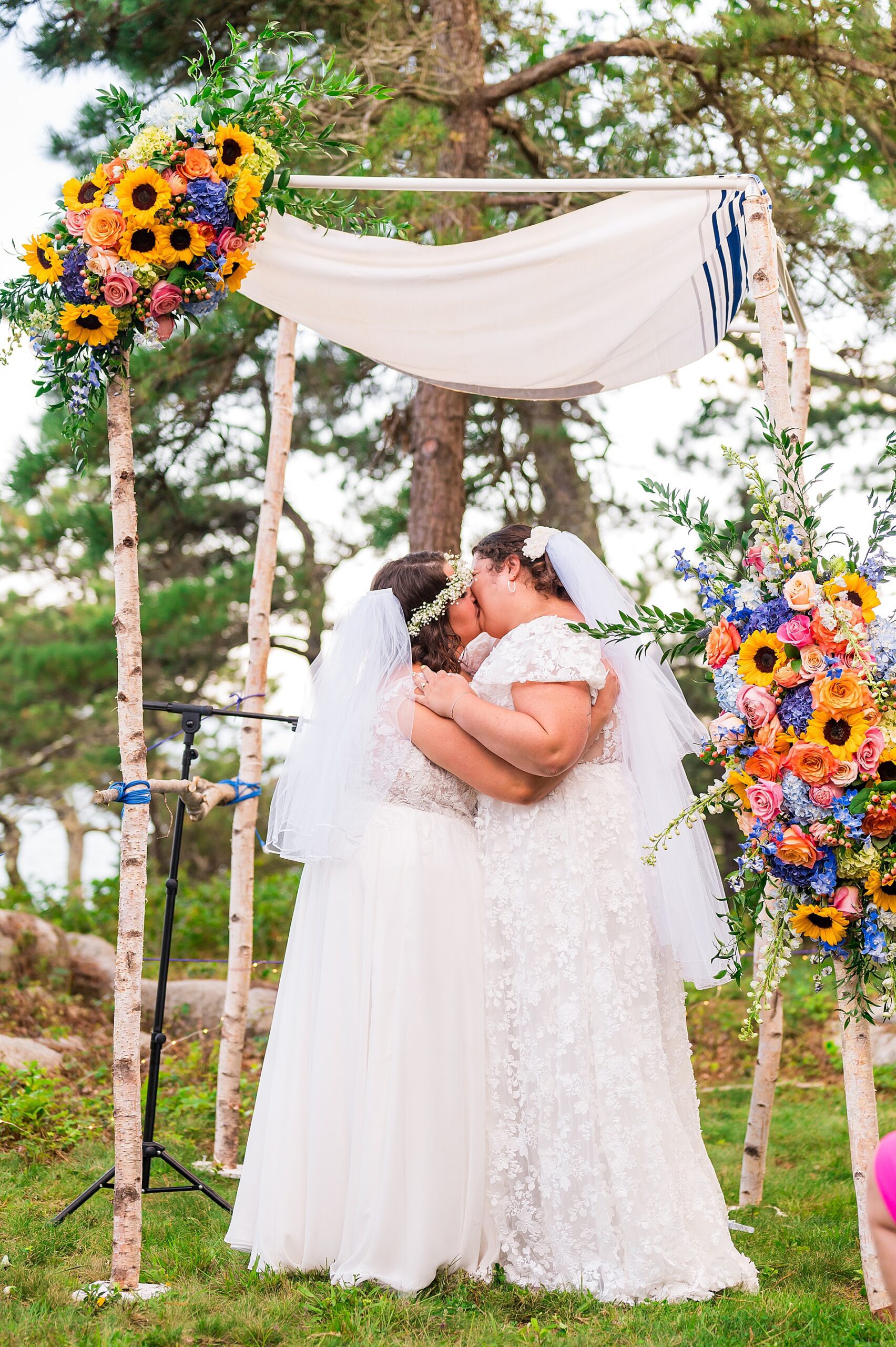 brides kiss at wedding ceremony