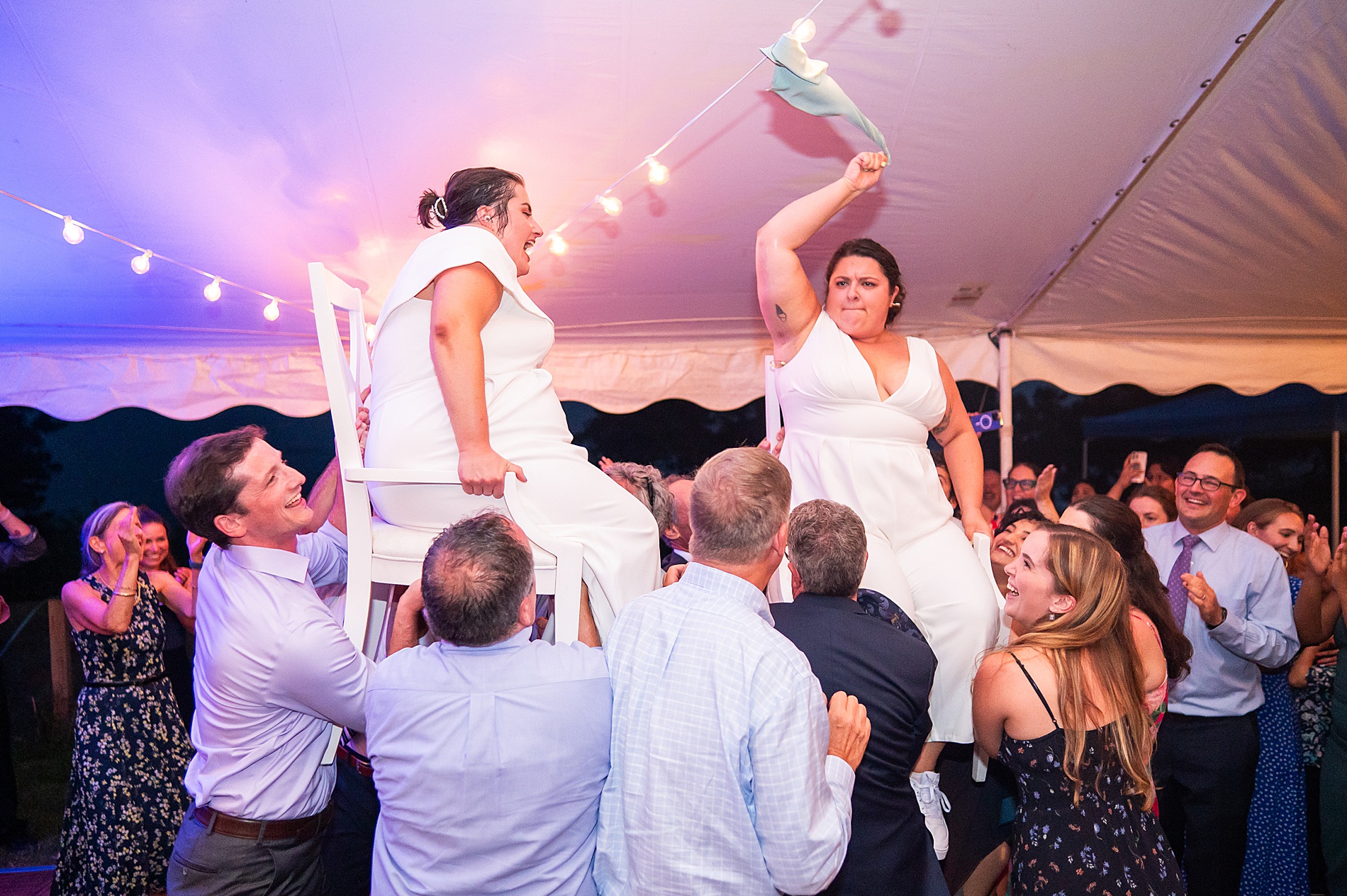 brides are lifted up in chairs during Jewish reception tradition 