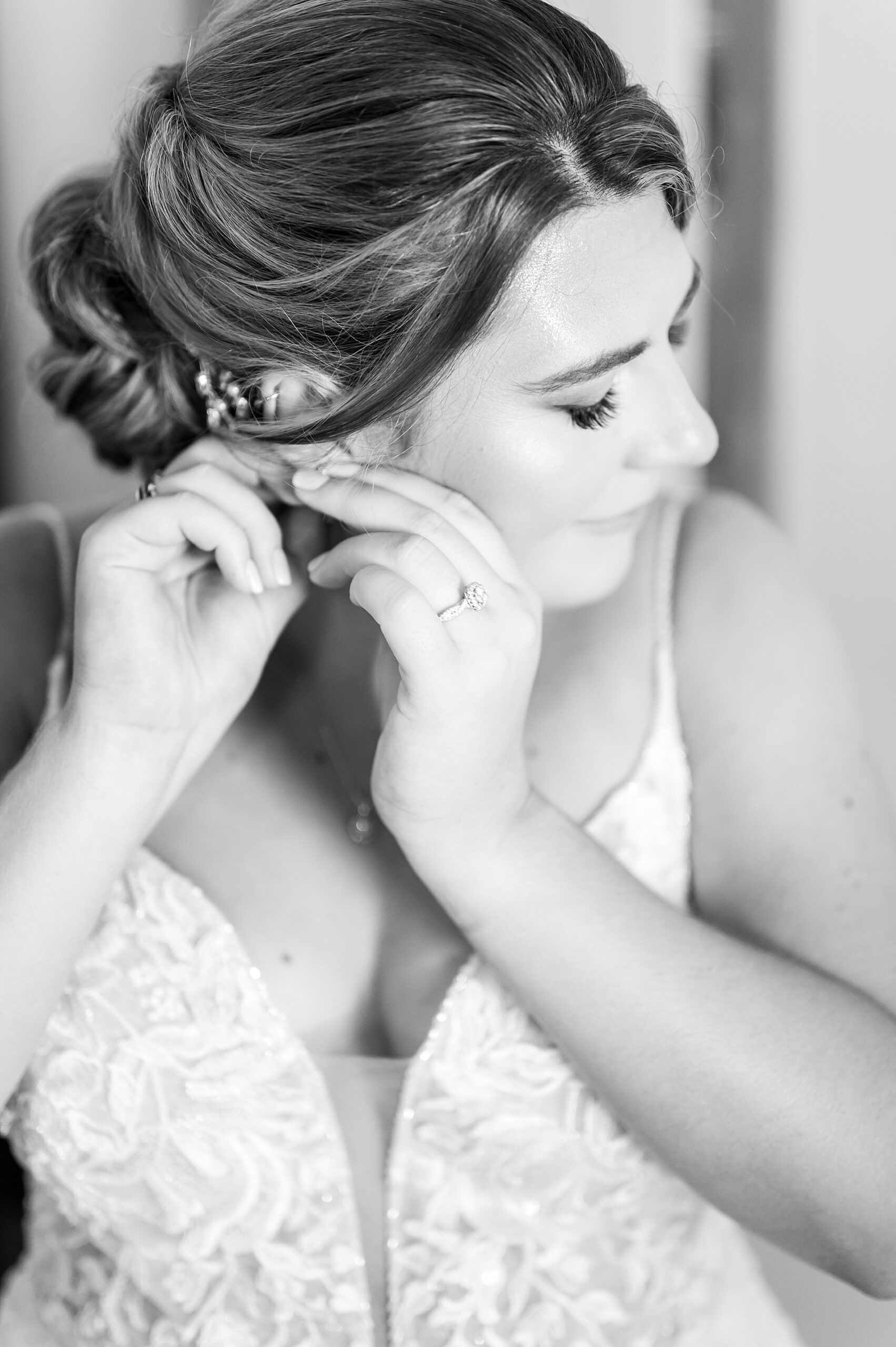 bride putting earrings in 