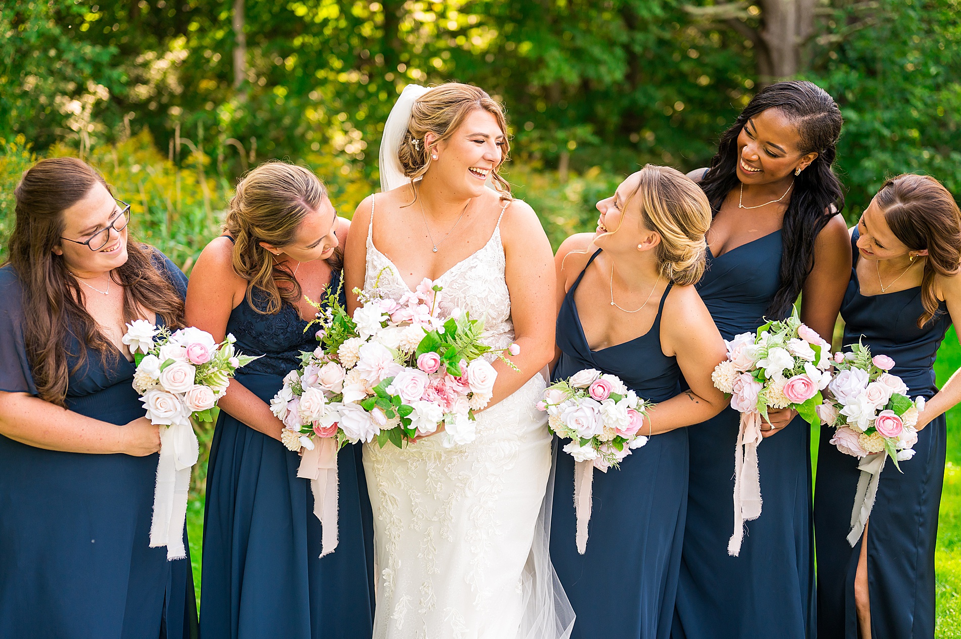 bride and bridesmaids in navy dresses