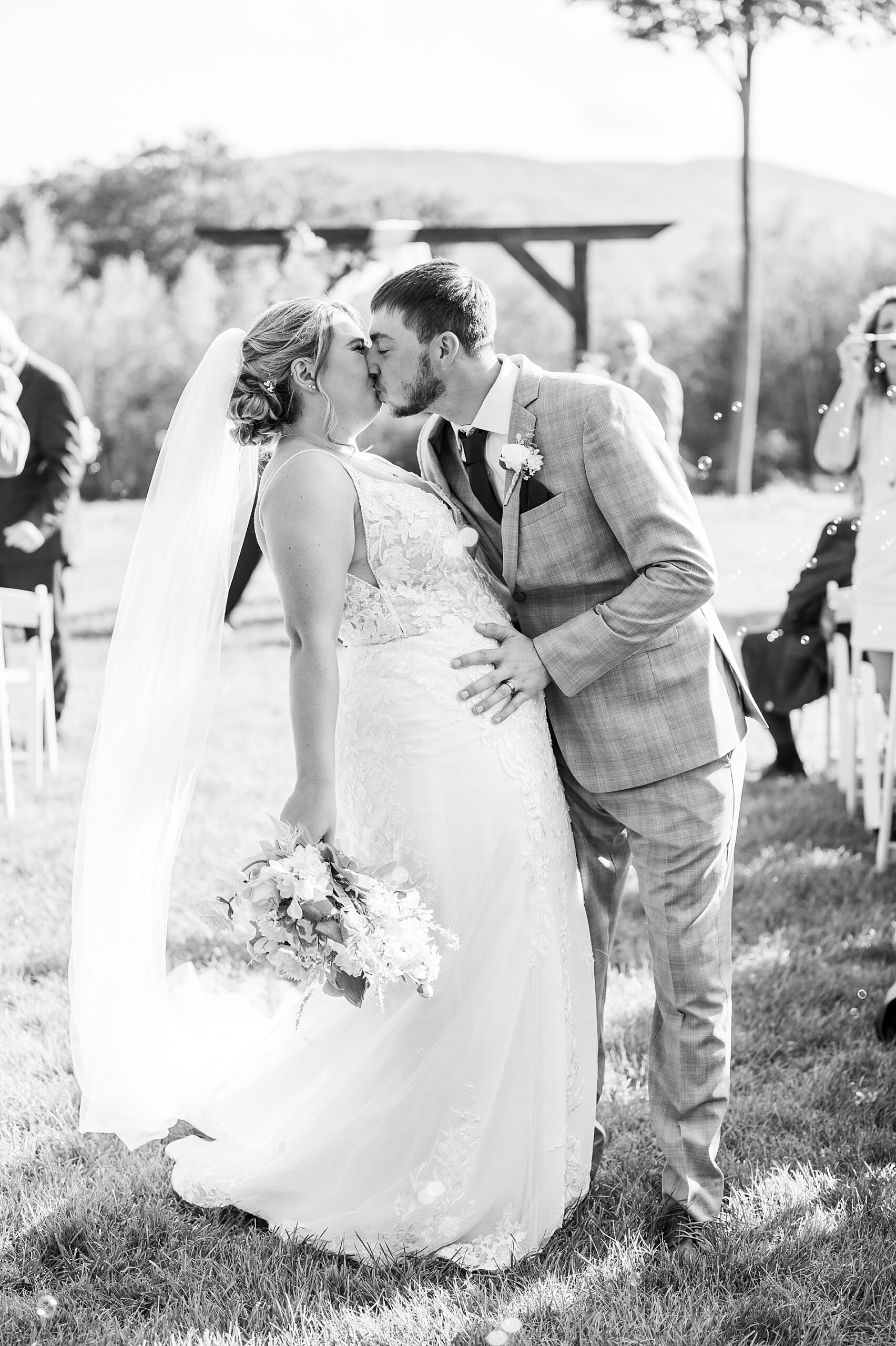 bride and groom kiss during Tumbledown Farm Wedding 